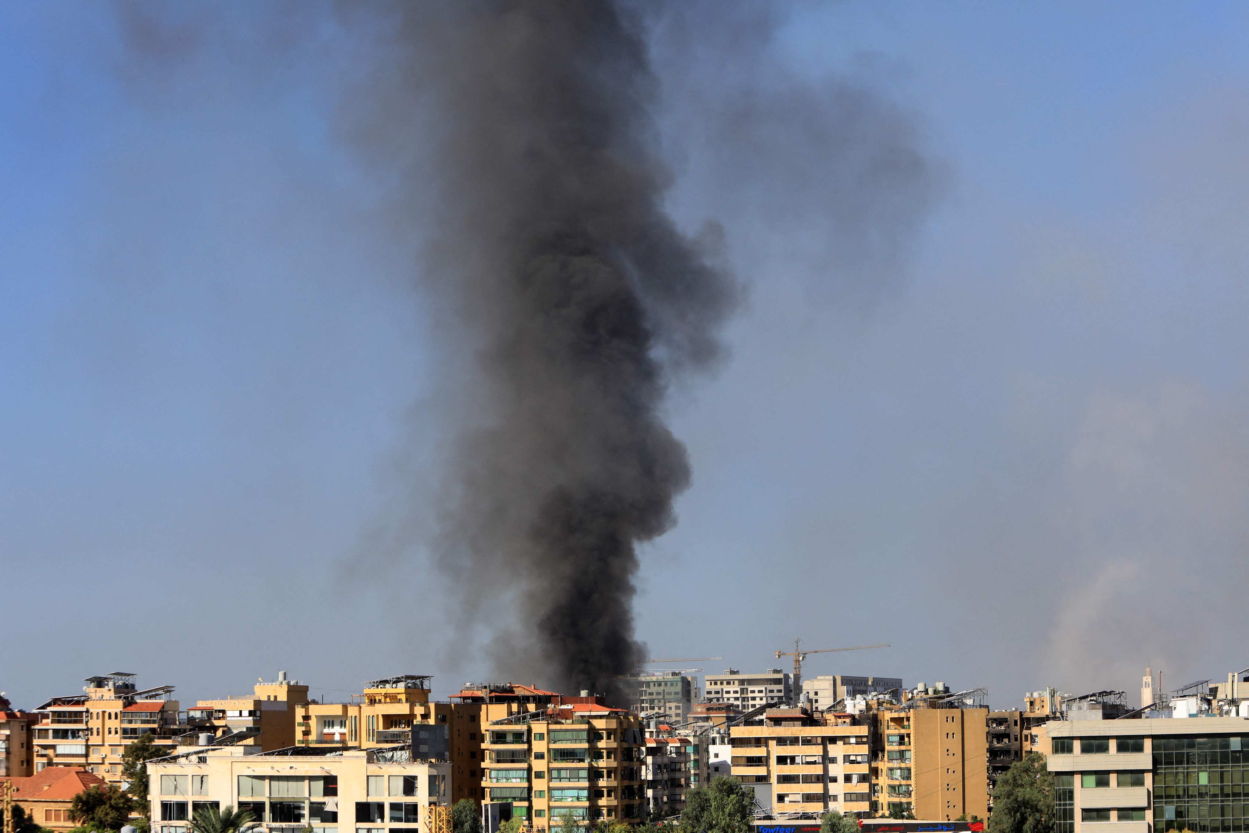 Smoke rises from buildings hit in an overnight Israeli airstrike that targeted Beirut’s southern suburbs on Thursday. Photo: AFP