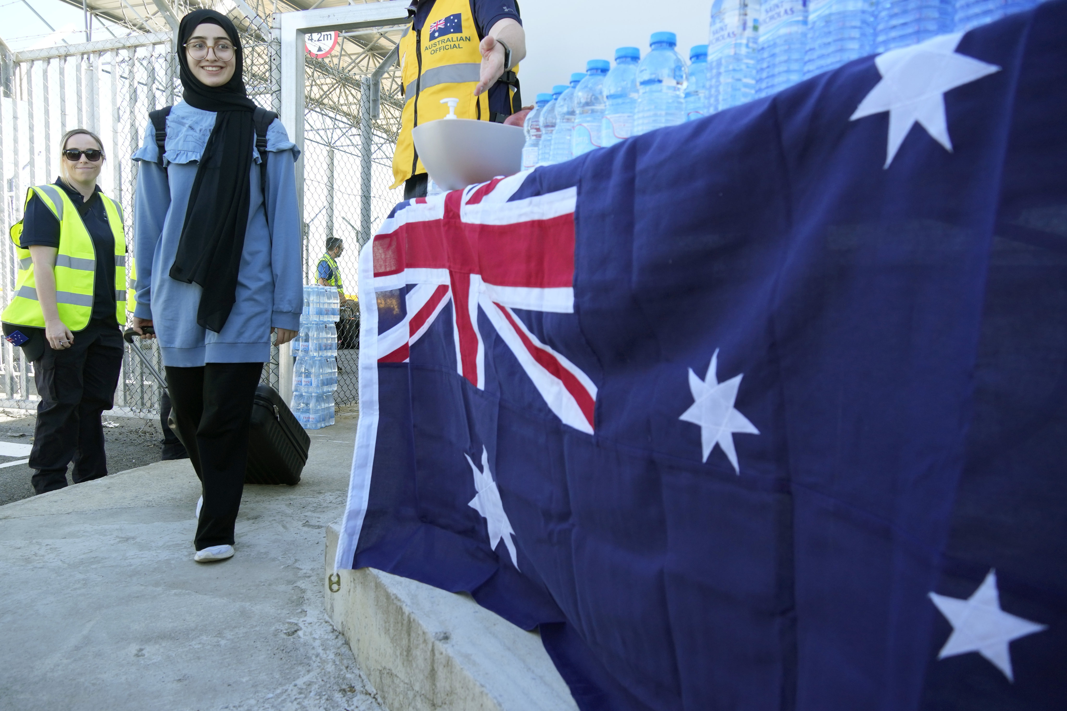 A woman, one of the 229 Australian nationals, arrives at Cyprus’ main airport of Larnaca after a chartered flight evacuated them from Lebanon, in Larnaca, Cyprus, on Saturday. Photo: AP