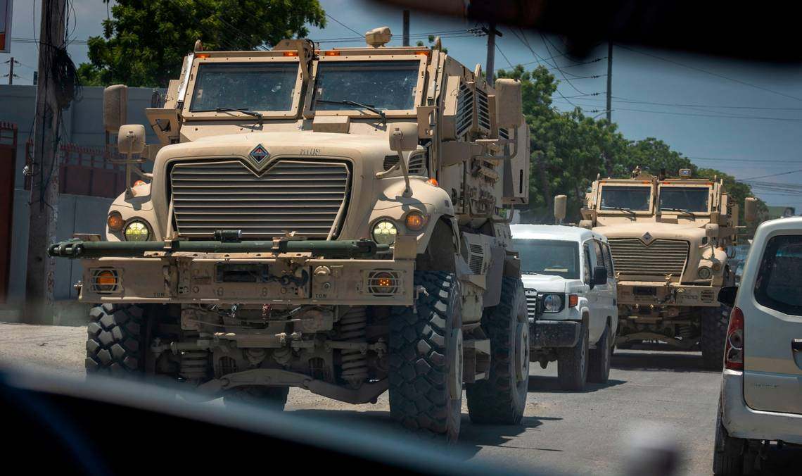 Armoured vehicles used by Kenyan police rumble through the streets of Port-au-Prince, Haiti. Photo: TNS