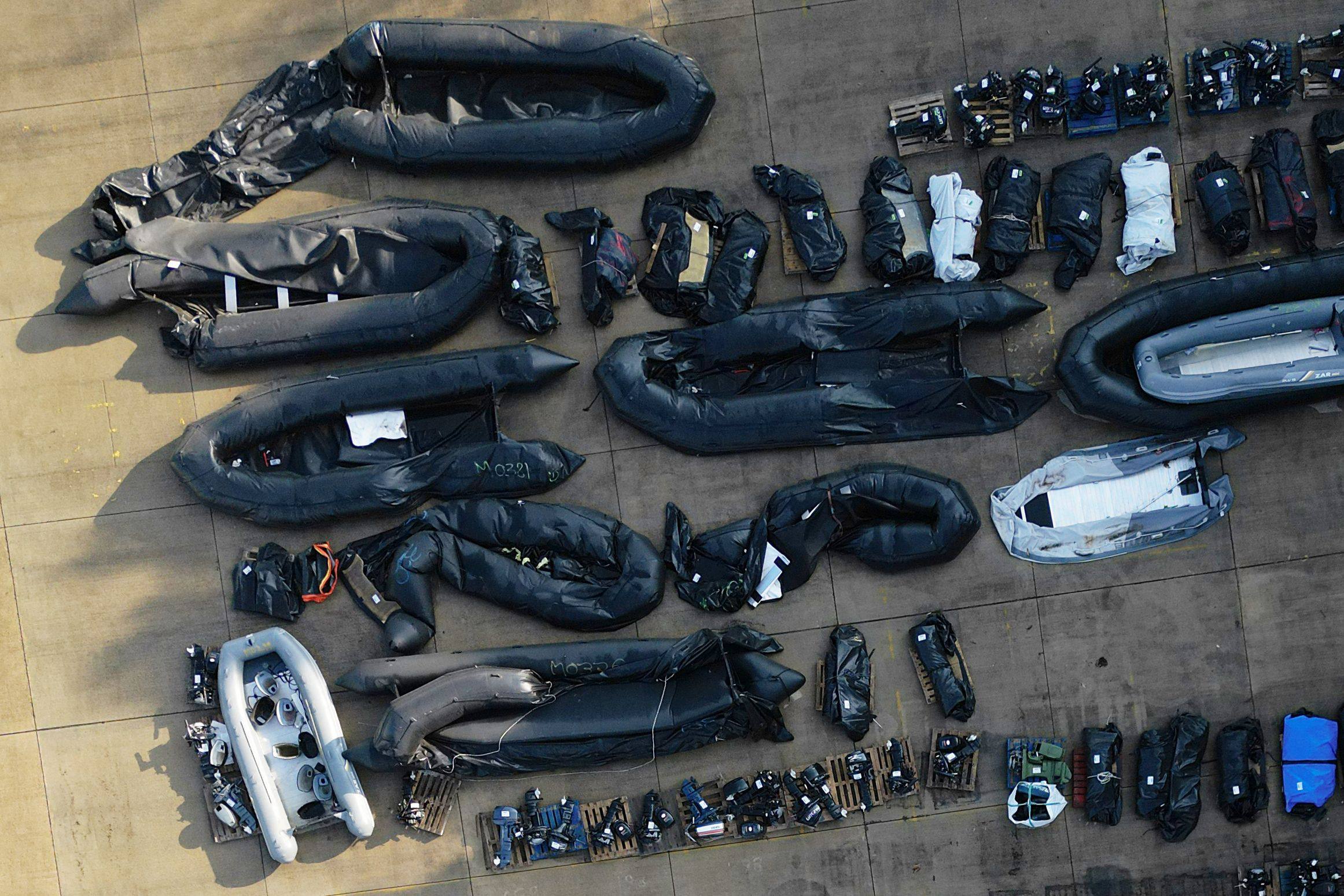 An aerial view taken on September 21 shows inflatable dinghies and outboard engines stored in a Port Authority yard in Dover, southeast England, that are believed to have been used by migrants who were picked up at sea whilst crossing the English Channel from France. Photo: AFP