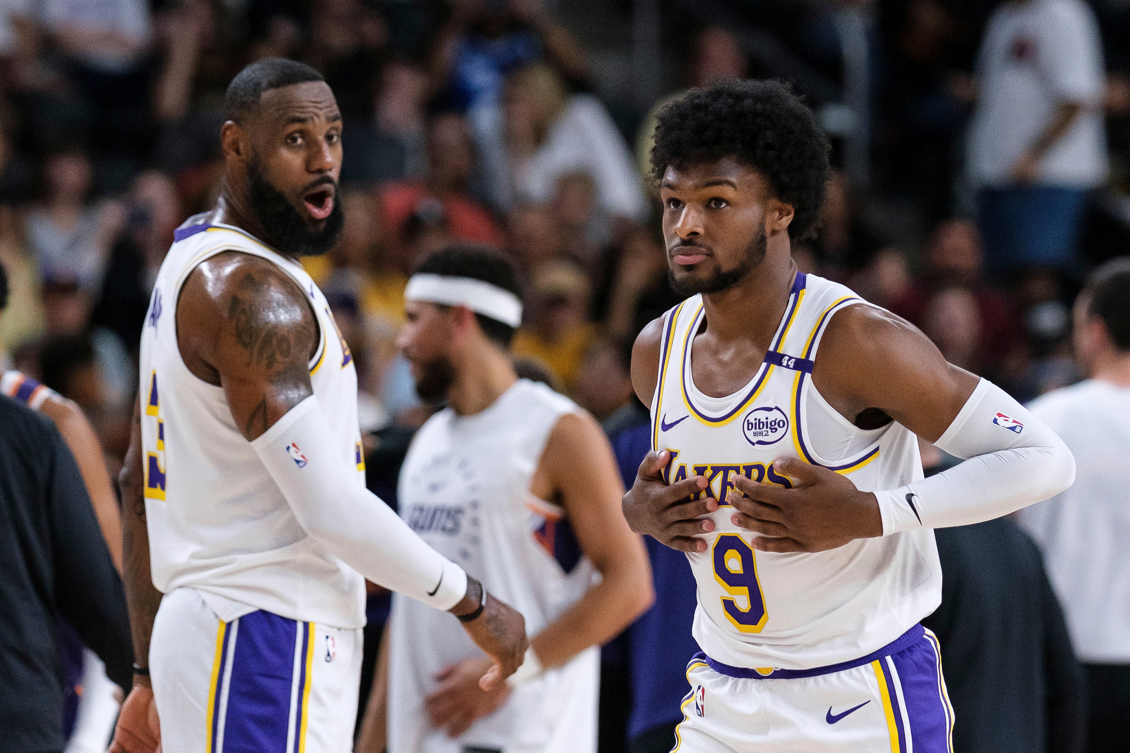 Los Angeles Lakers guard Bronny James (right) steps onto the court with Lakers forward LeBron James during the preseason NBA game against the Phoenix Suns. Photo: AP