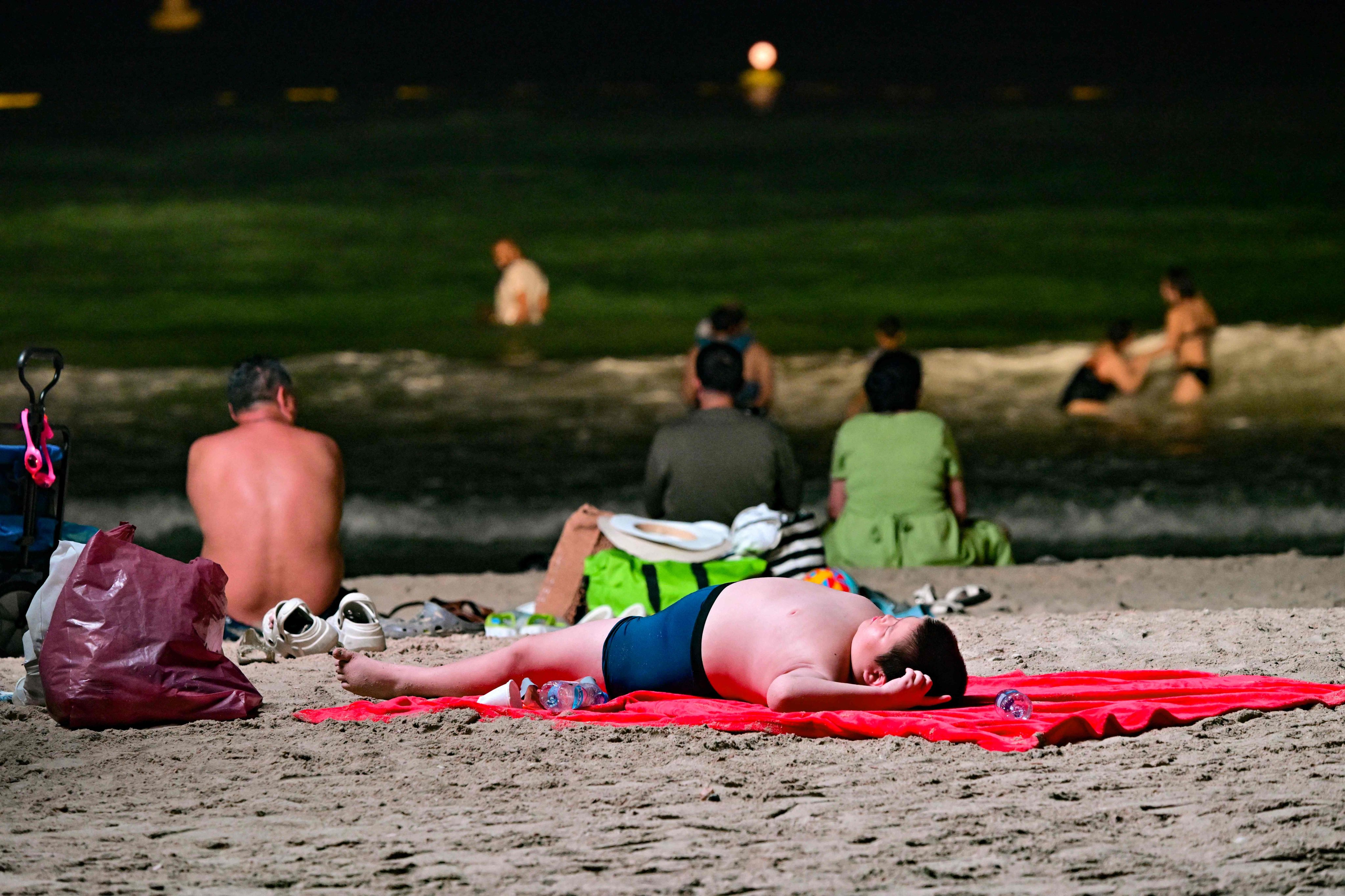 Roasted by daytime summer temperatures too hot for the beach, Dubai has turned to an innovative solution: opening beaches at night. Photo: AFP