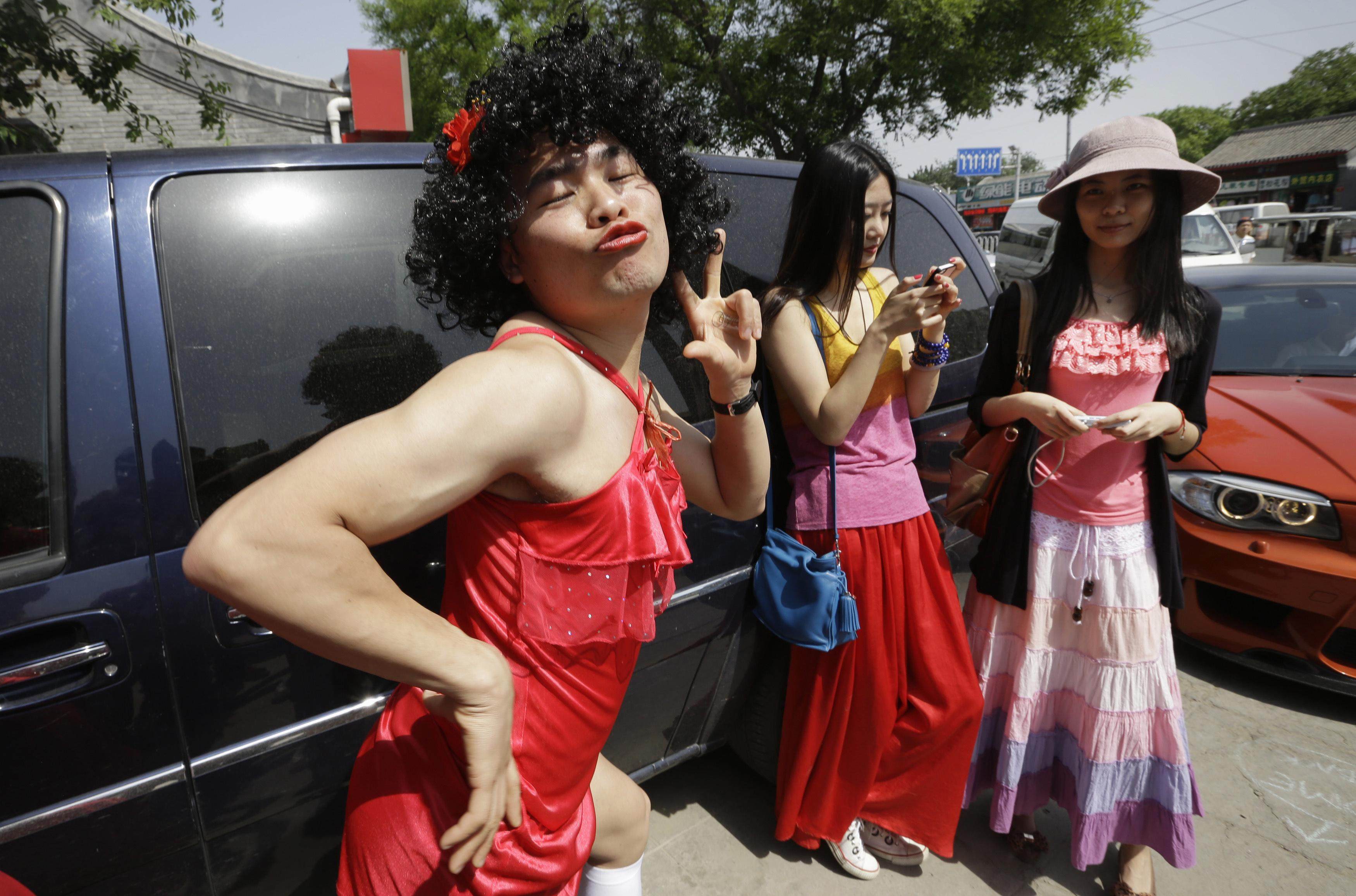 A man wearing a red dress poses for a photo before a hash event in Beijing in 2013. One of the accused said in his defence that it was not unusual for men to wear women’s clothing during hash events. Photo: Reuters 