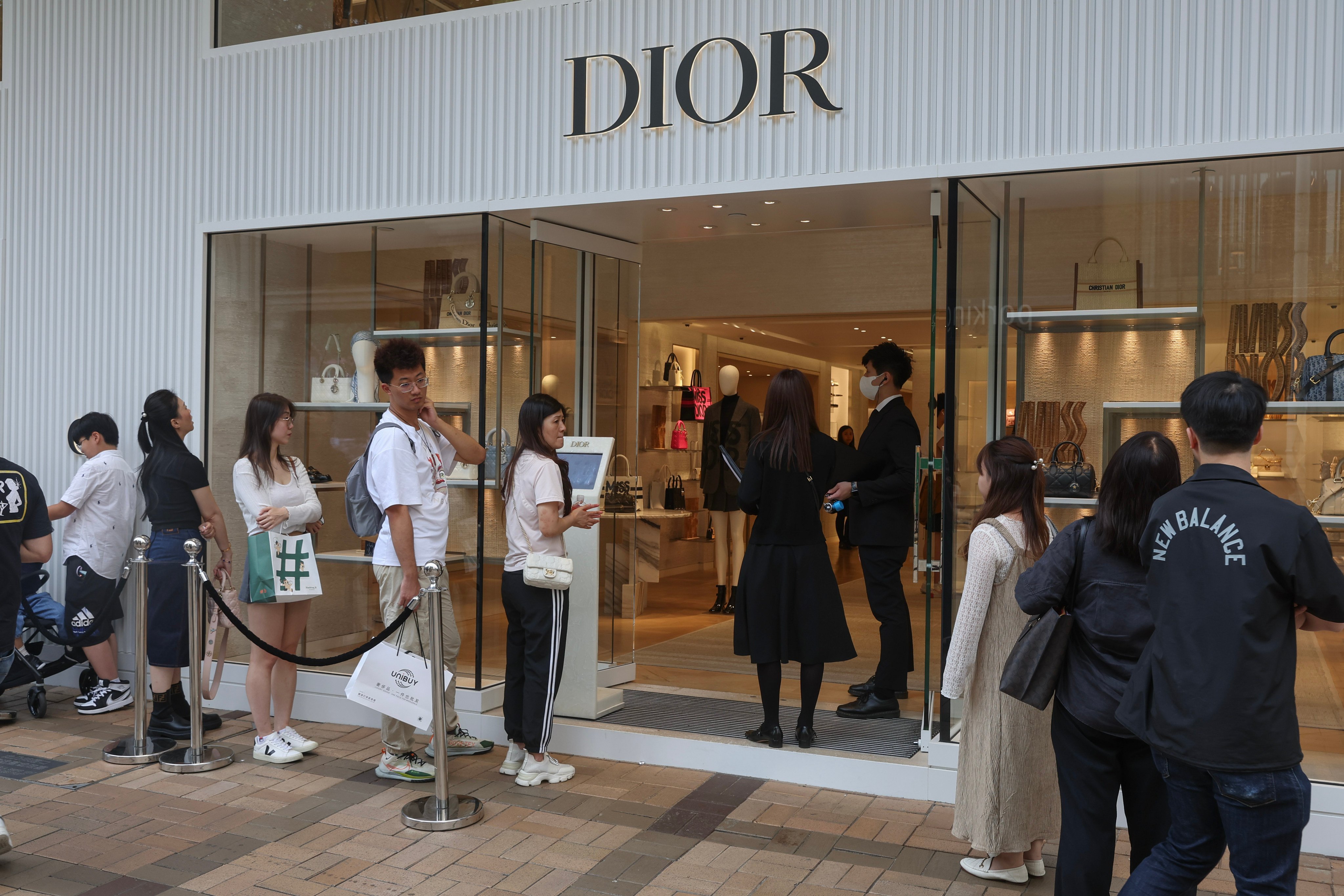 Shoppers and tourists line up at a luxury fashion brand store in Hong Kong during the Golden Week holiday. Photo: Edmond So