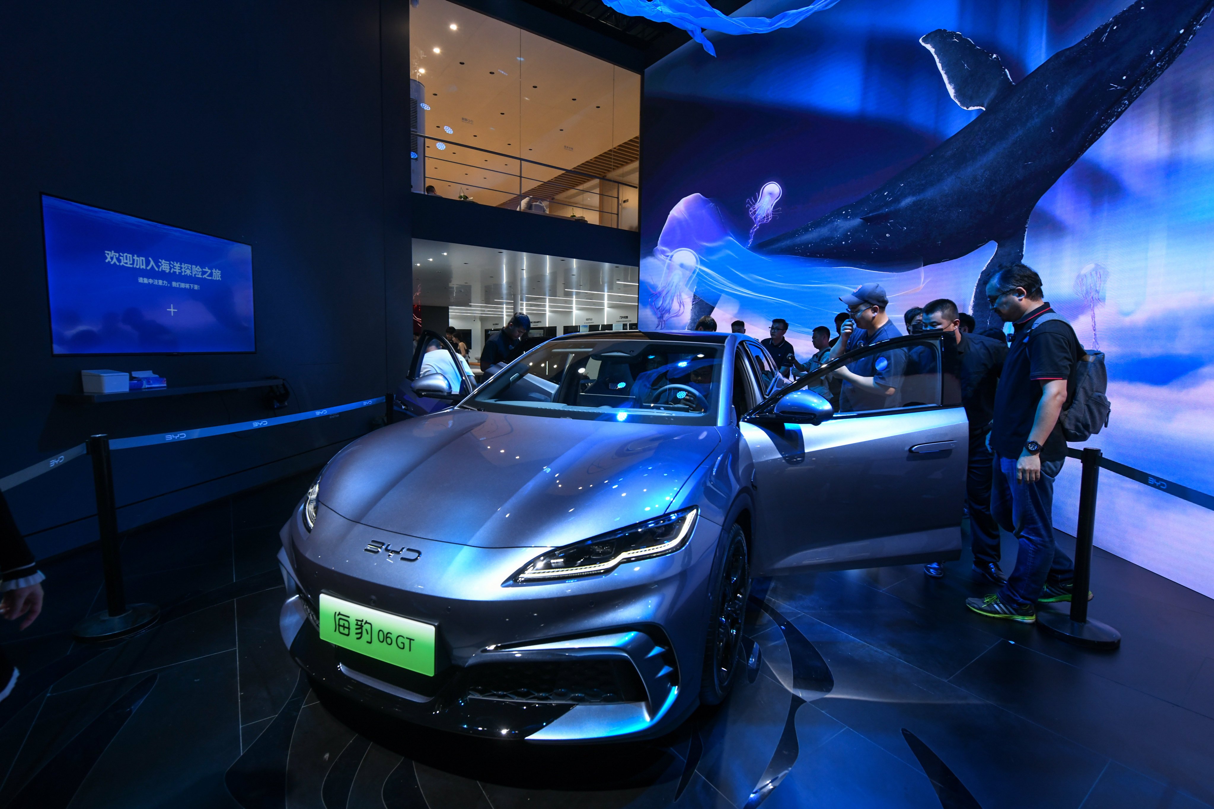 Car enthusiasts check out a BYD Seal electric car. Cars dealers on mainland Chinese did brisk sales during the golden week holiday. Photo: Xinhua