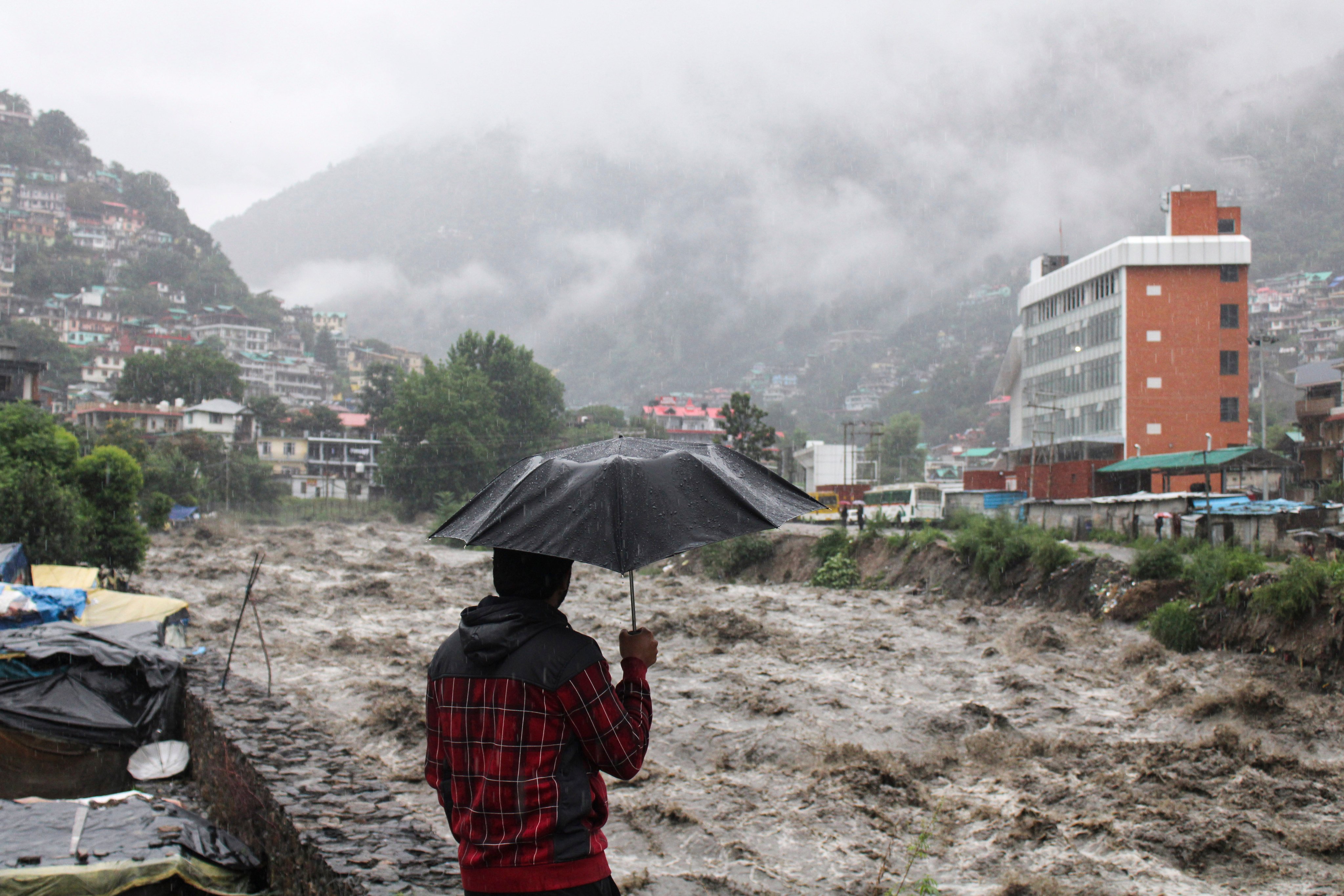 A man looks at a swollen River Beas following heavy rains in Kullu, Himachal Pradesh, India, last year. Photo: AP