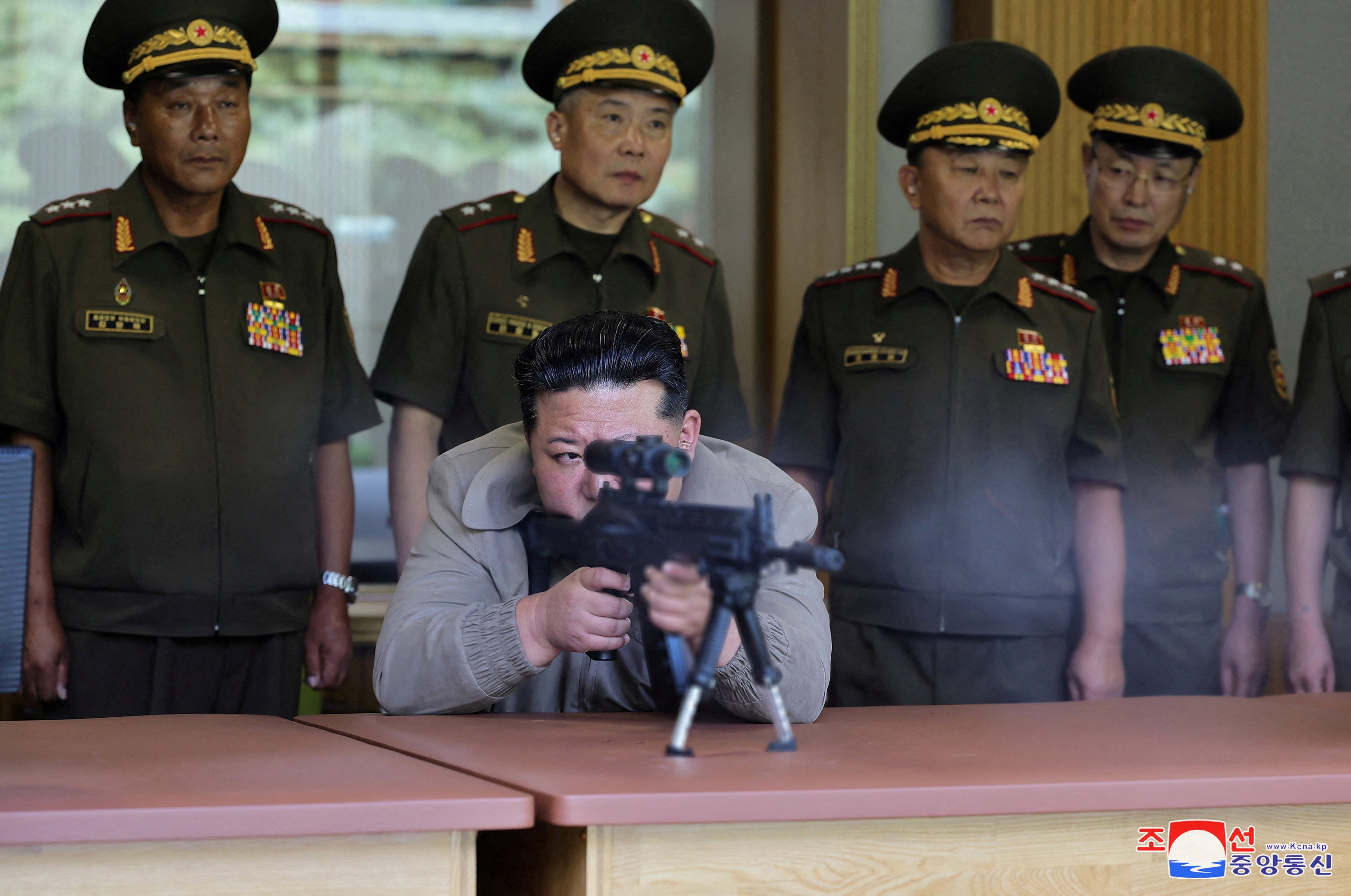 North Korean leader Kim Jong-un (centre) fires a sniper rifle at an undisclosed location in North Korea. Photo: KCNA via Reuters