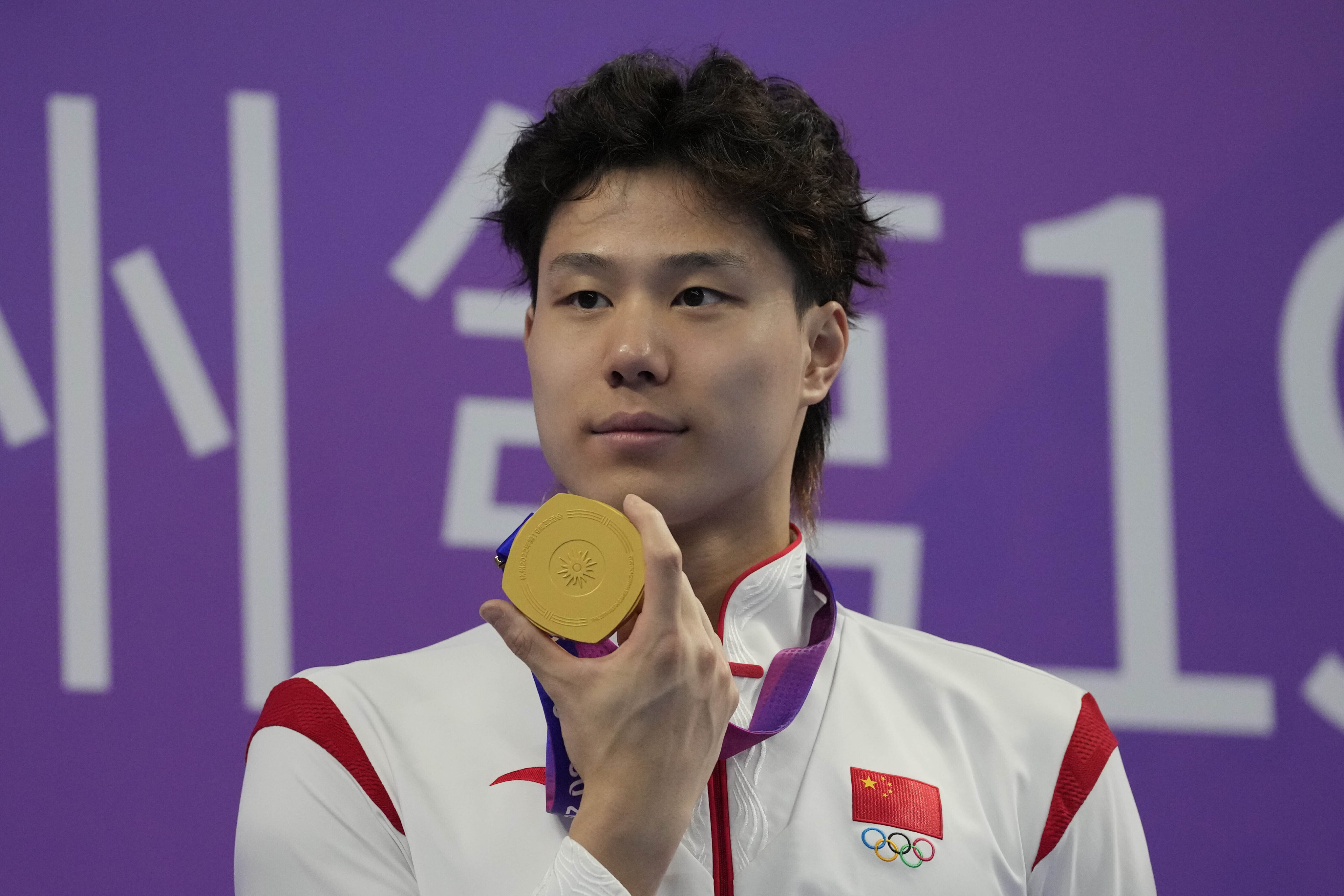 Qin Haiyang is awarded his Asian Games gold medal in the 50m breaststroke in Hangzhou last year. Photo: AP