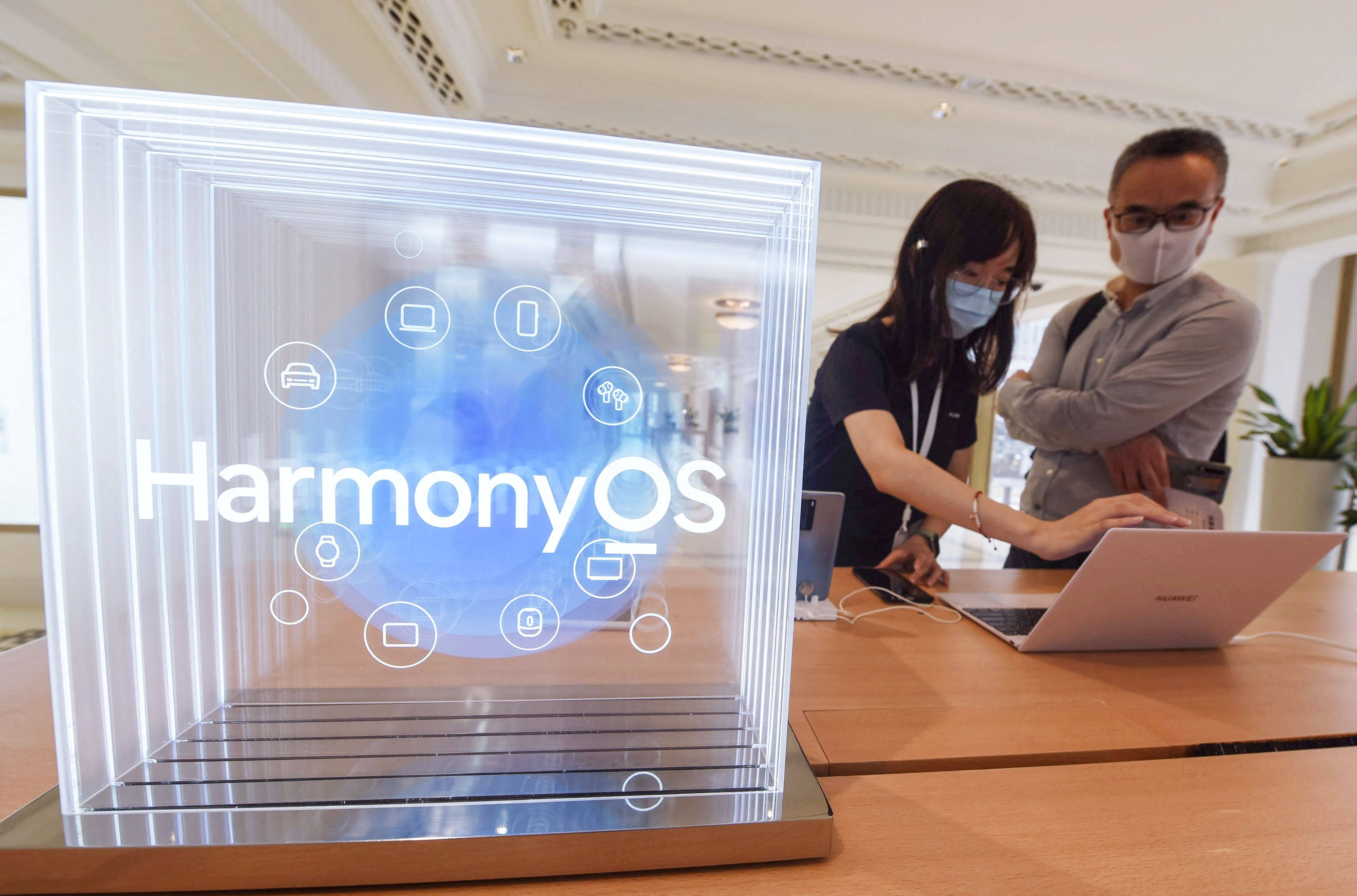 Customers try Huawei products using the HarmonyOS operating system at a Huawei store in Shanghai, June 3, 2021. Photo: AFP