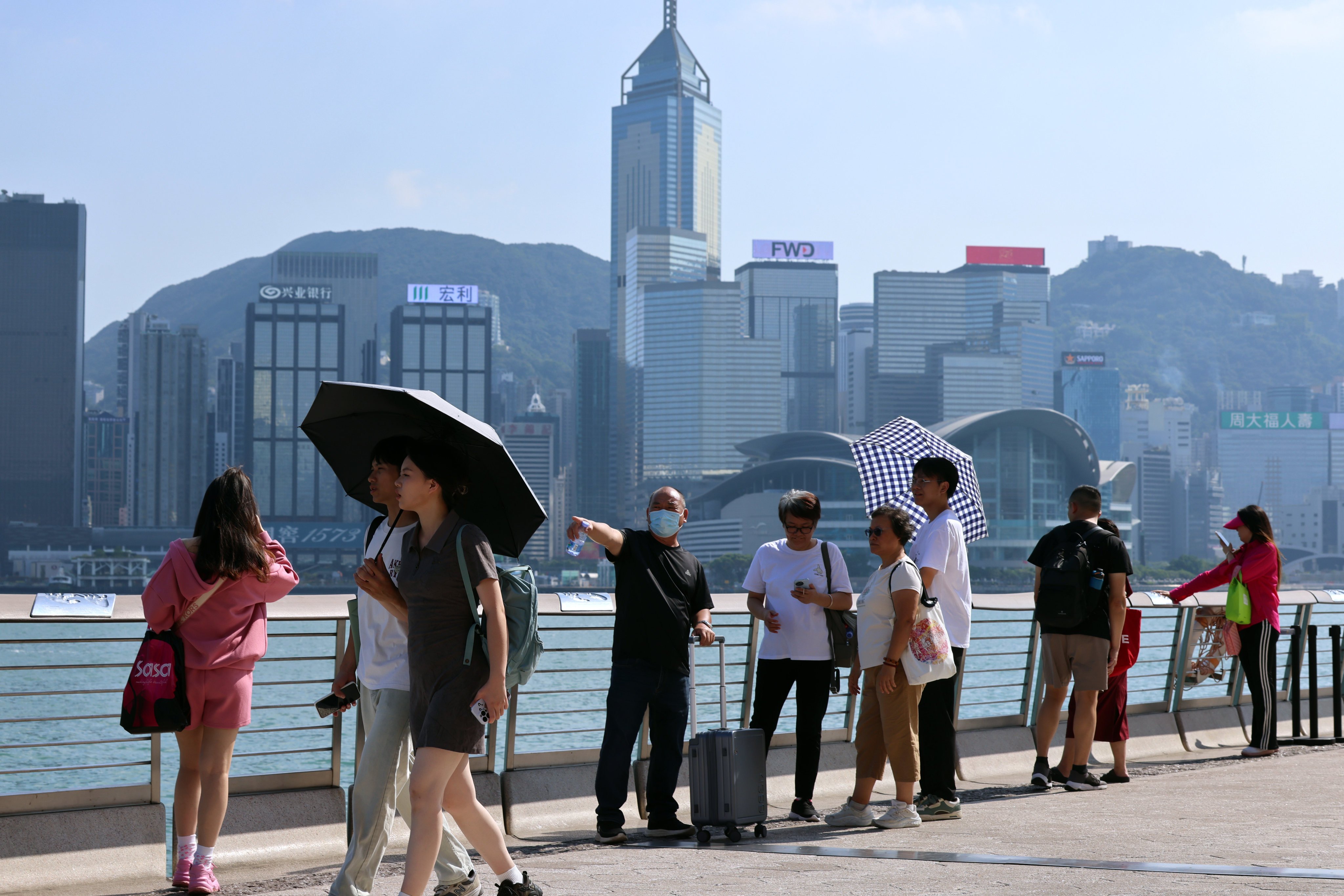 Tourists visit the Avenue of Stars in Tsim Sha Tsui during the “golden week” holiday. While the mainland usually enjoys a week off for National Day, Hongkongers only get one extra day off. Photo: Jelly Tse