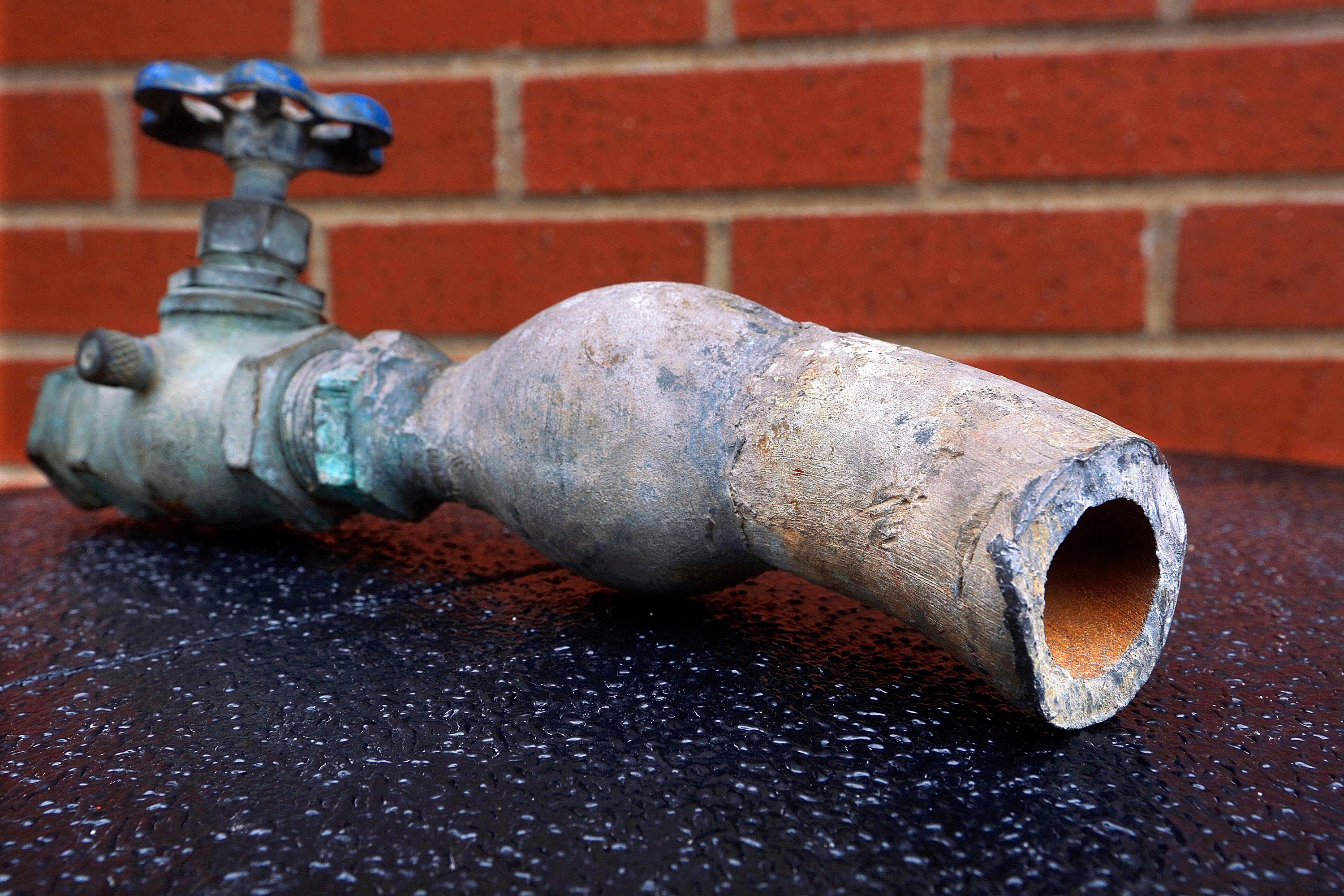 City officials display a lead pipe in Galesburg, Illinios. Photo: AP