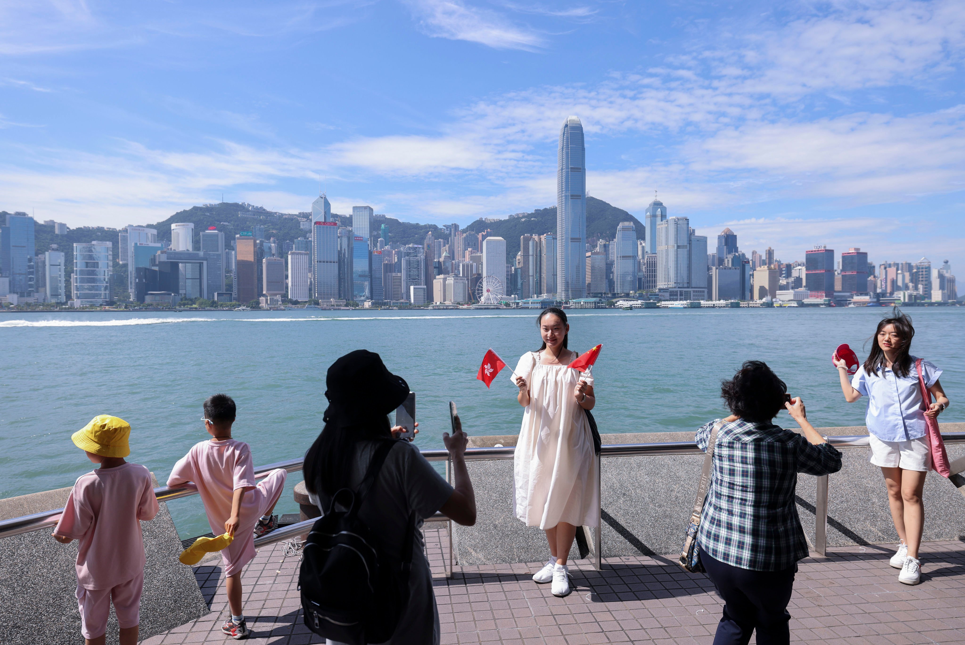 Visitors take pictures in Tsim Sha Tsui during the National Day “golden week” holidays. Photo: Nora Tam