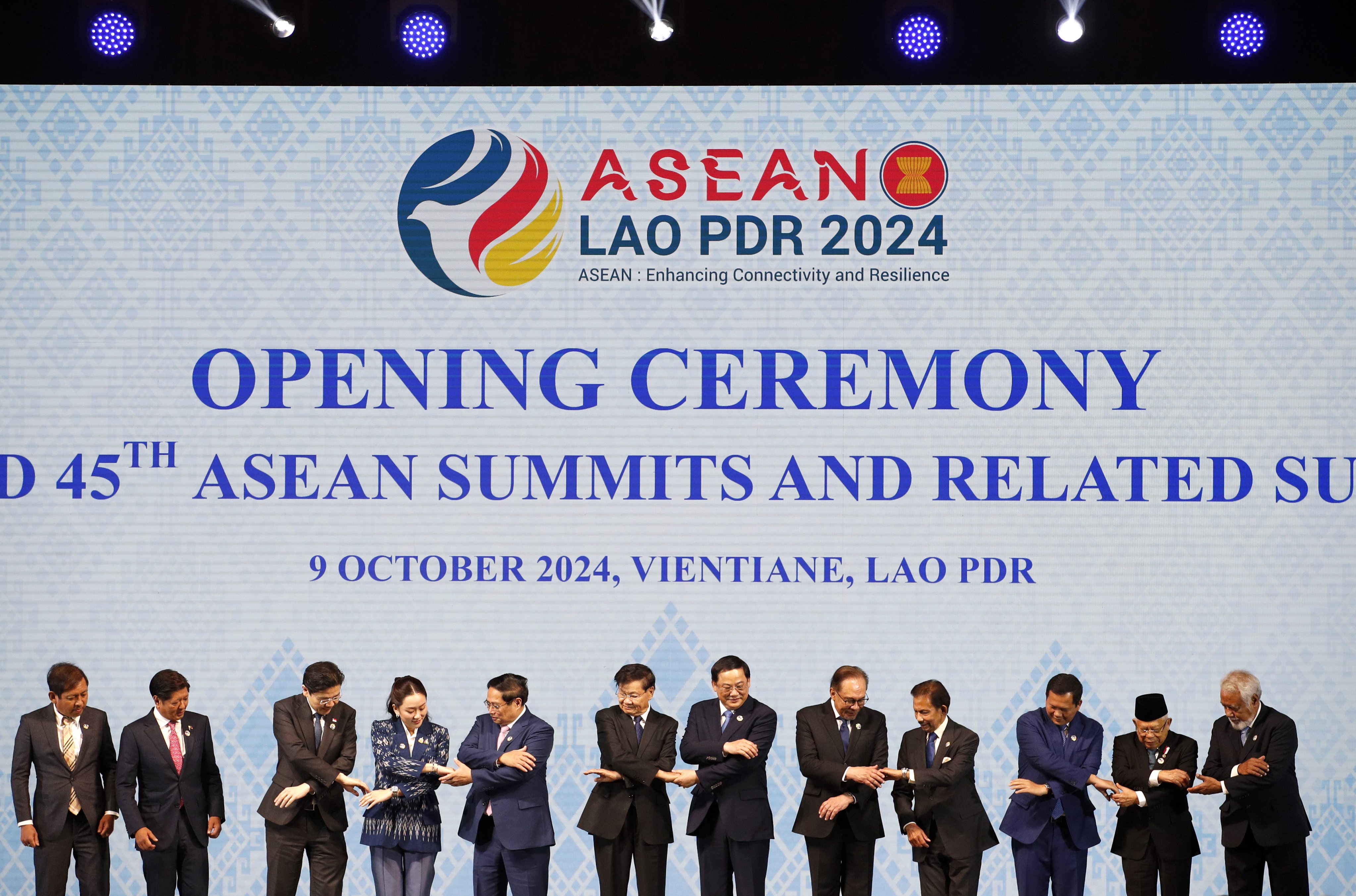Asean leaders reach for each other’s hands during a group photo at the opening ceremony of the Asean Summit in Vientiane, Laos, on Wednesday. Photo: EPA-EFE