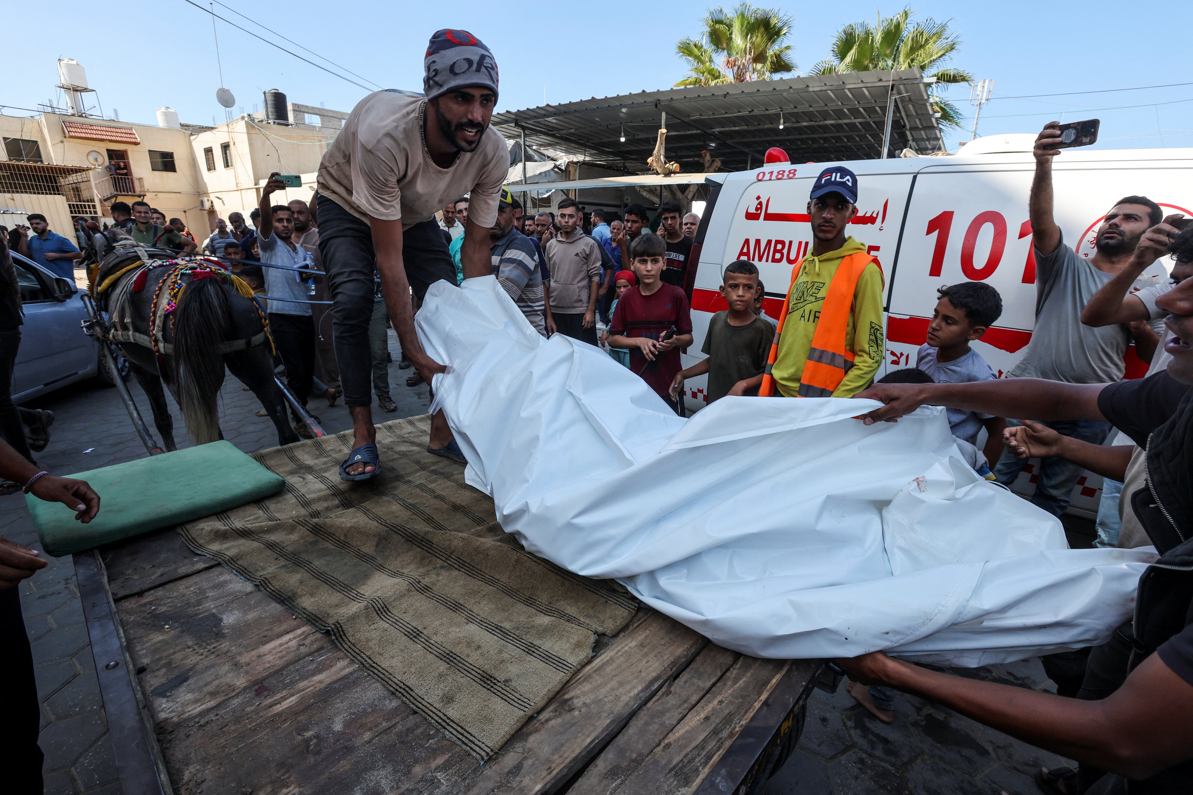 A body is brought to Al-Aqsa Martyrs Hospital after an Israeli strike on a school sheltering displaced people, in Deir Al-Balah, Gaza. Photo: Reuters