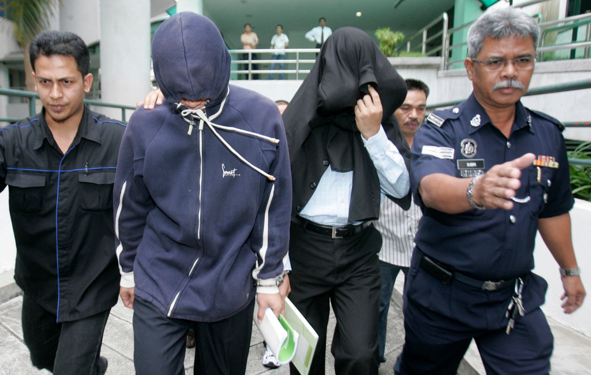 Policemen Azilah Hadri and Sirul Azhar Umar arrive at the courthouse in Shah Alam outside Kuala Lumpur in 2009. Photo: Reuters 