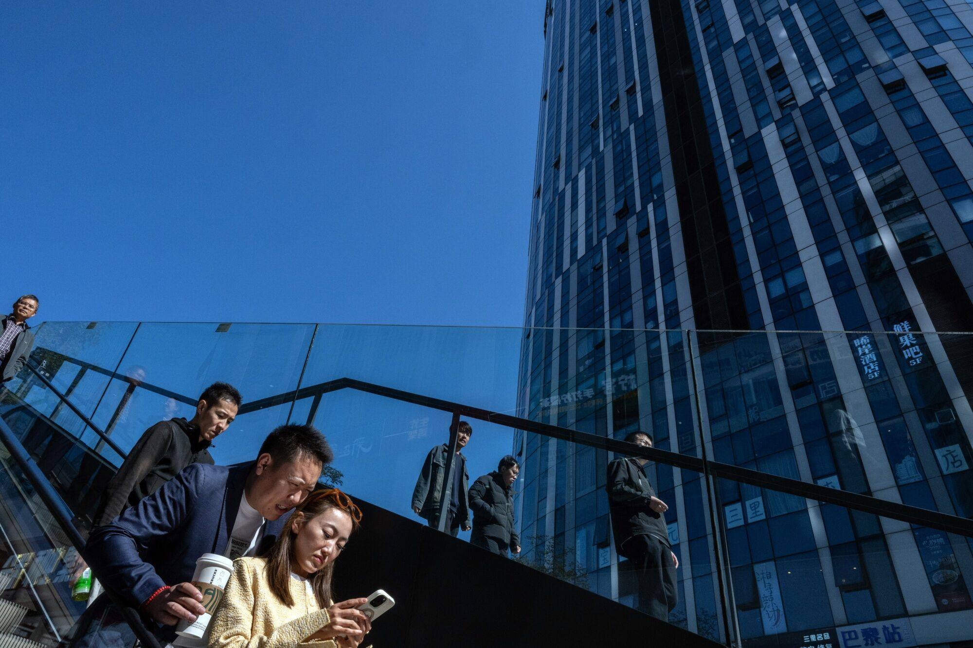 Pedestrians in Beijing on October 8, two weeks after China’s central bank announced stimulus measures to support the economy. Photo: Bloomberg 