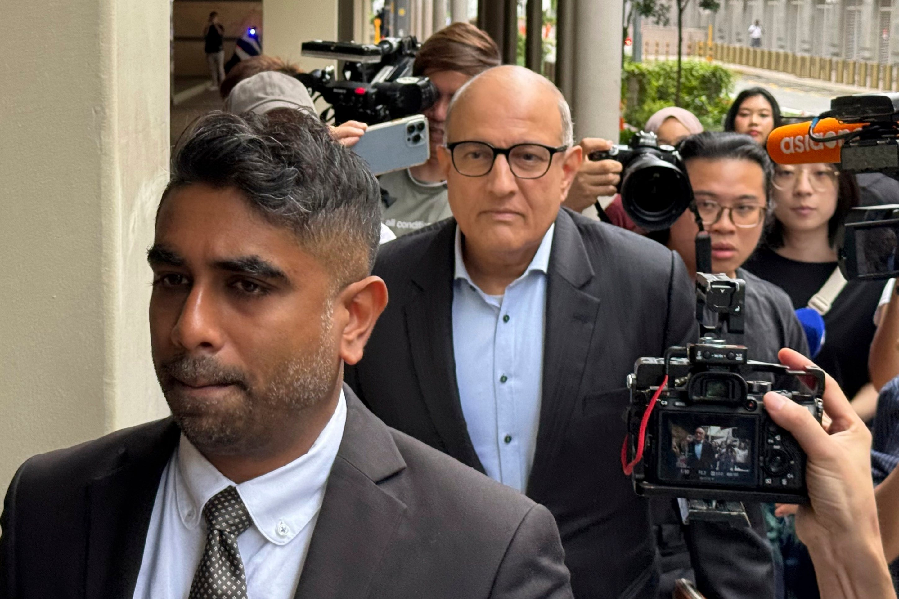 Former transport minister S. Iswaran (centre) and his lawyer at the High Court in Singapore on October 3, 2024. Photo: AP