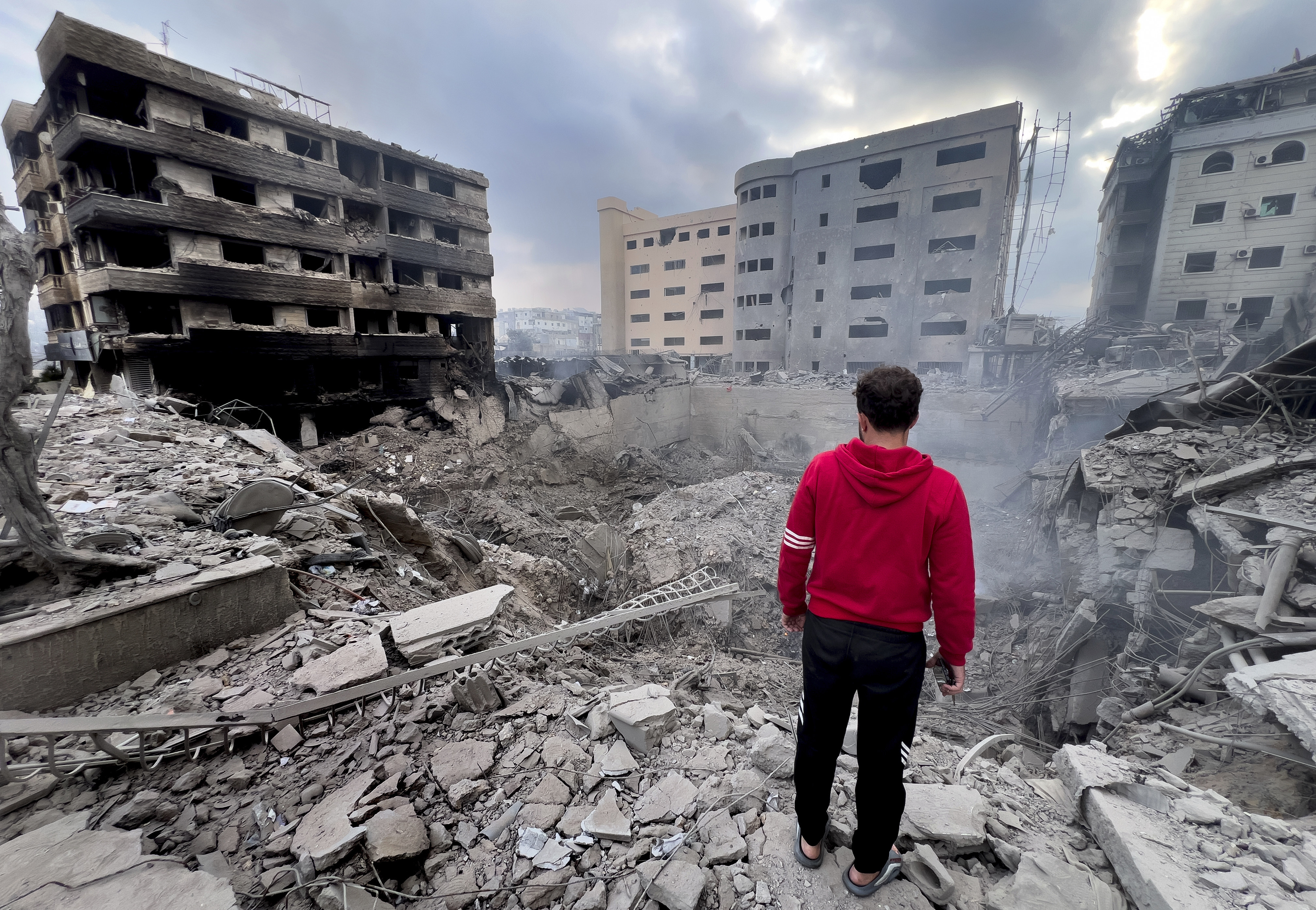 A man looks at destroyed buildings hit by Israeli air strikes in Dahiyeh, Beirut, Lebanon. Photo: AP