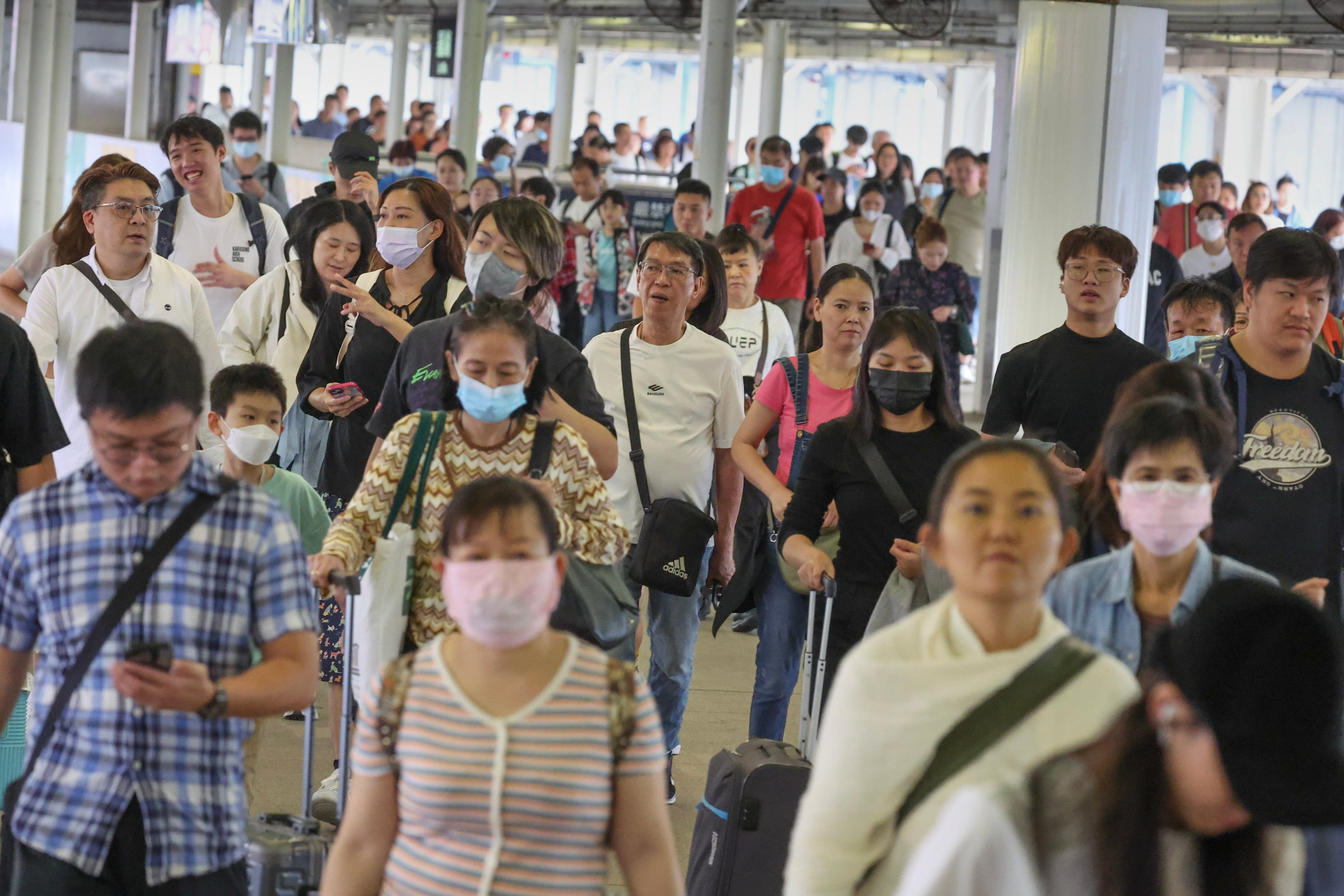 Passengers pass through the Lo Wu checkpoint heading to Shenzhen during the Chung Yeung Festival. Photo: Dickson Lee