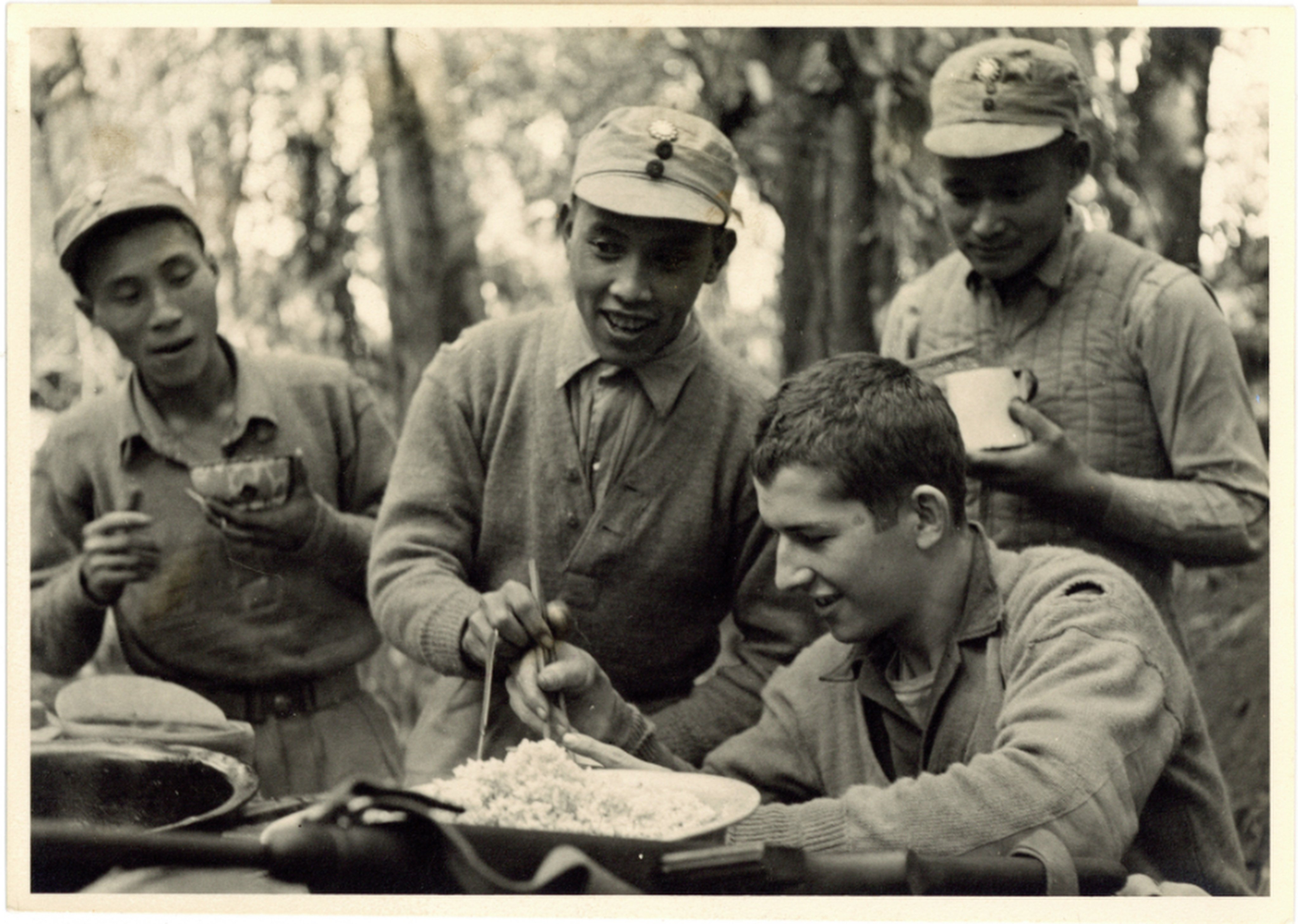 An exhibition of photos taken during WWII of Chinese and US soldiers serving side by side - including this image of US soldier Edward McNamara being taught to use chopsticks - has opened in Beijing. Photo: Zou Dehuai