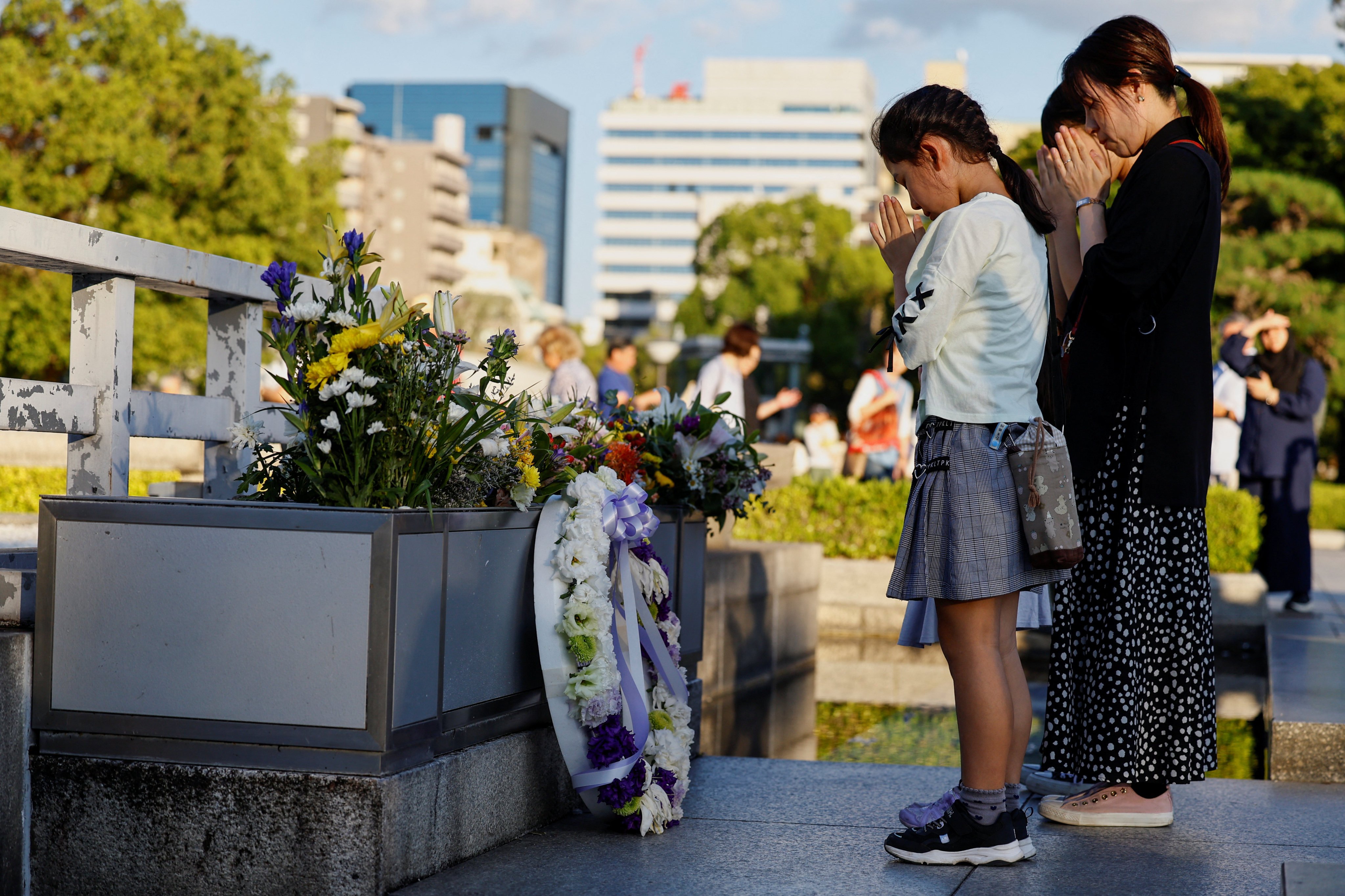 Visitors pray in front of the Cenotaph for the Victims of the Atomic Bomb at the Hiroshima Peace Memorial Park, the day after the Japan Confederation of A- and H-Bomb Sufferers Organizations (Nihon Hidankyo) won the 2024 Nobel Peace Prize, in Hiroshima, Japan, on Saturday. Photo: Reuters