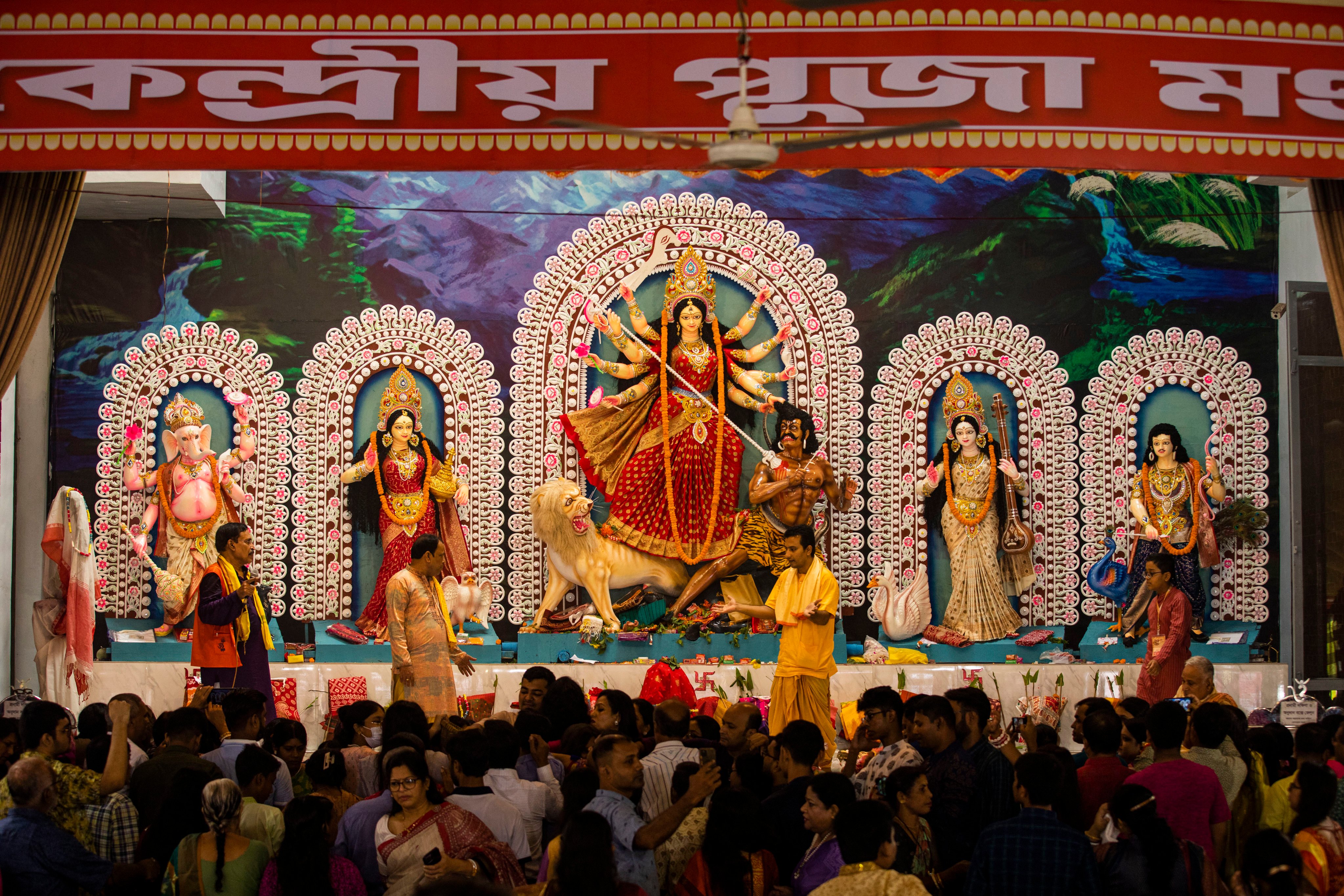 A tableau depicting the slaying of demon Mahishasura by the Hindu goddess Durga, center, is installed with other gods at Dhakeshwari National Temple during the Durga Puja festival in Dhaka, Bangladesh, on Thursday. Photo: AP