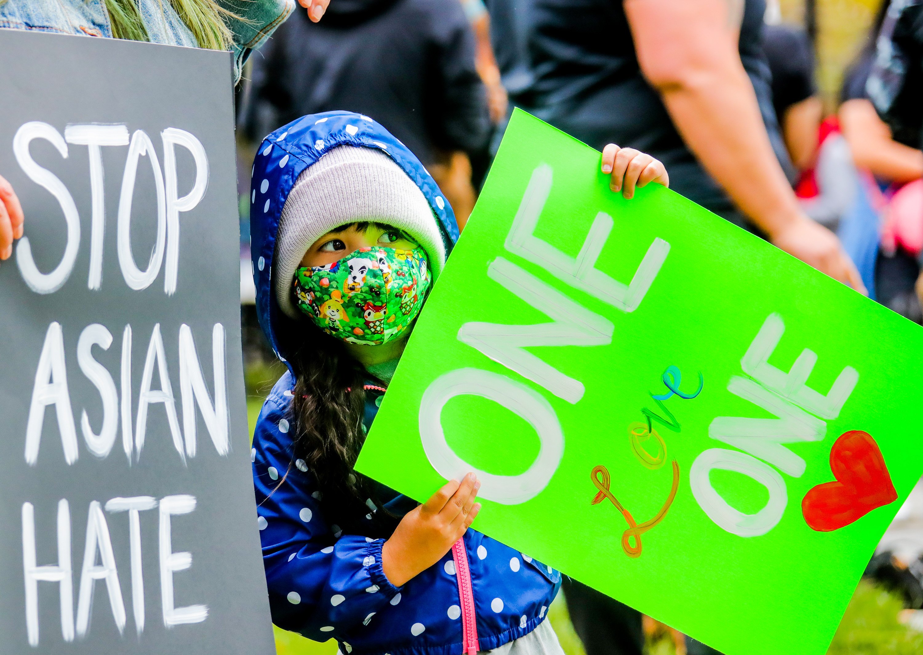 A child holds up a sign at a Stop Asian Hate rally in San Jose, California, in April 2021. Photo: Xinhua