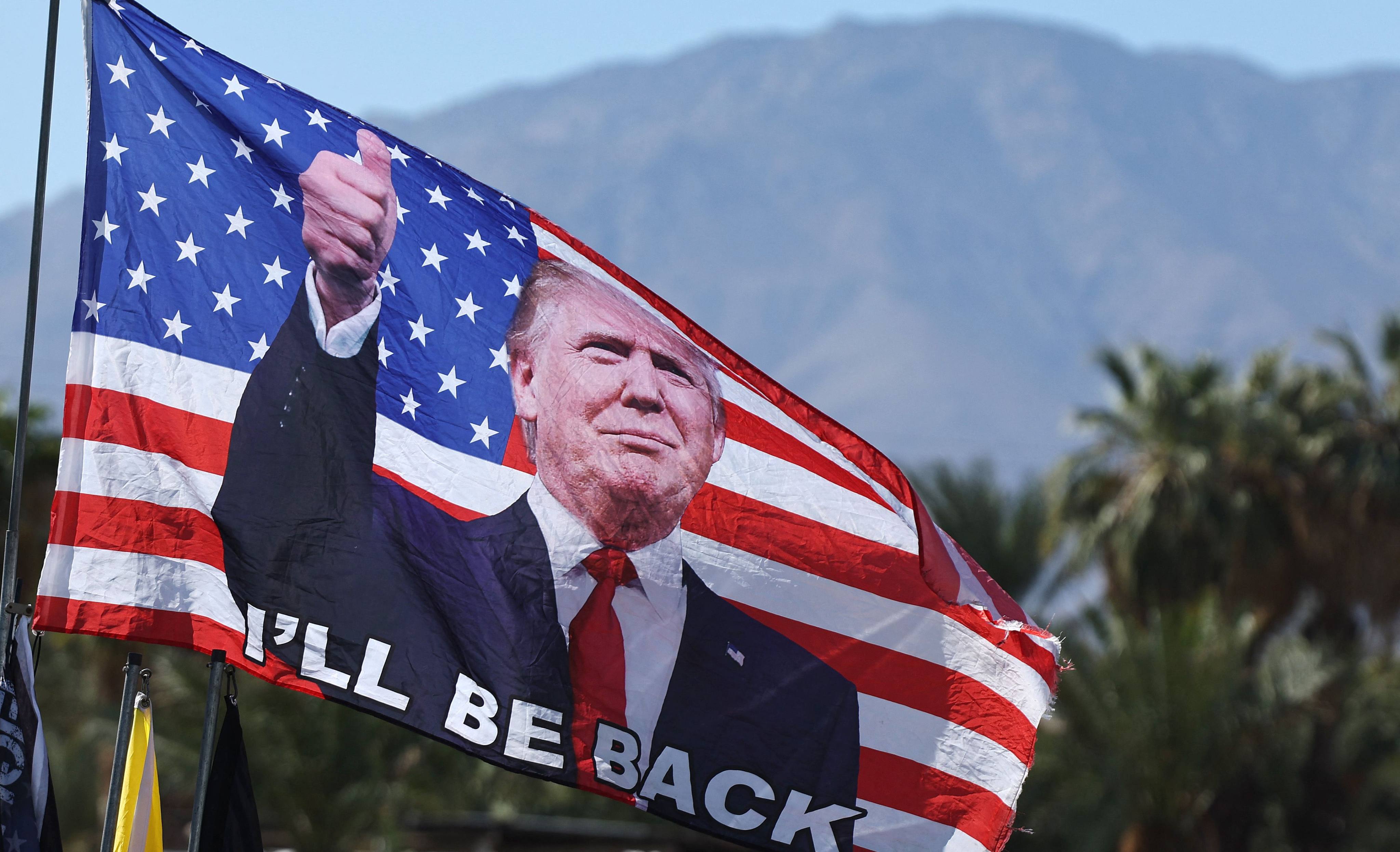 A Trump flag flies before a campaign rally in Coachella, California, on Saturday. Photo: AFP
