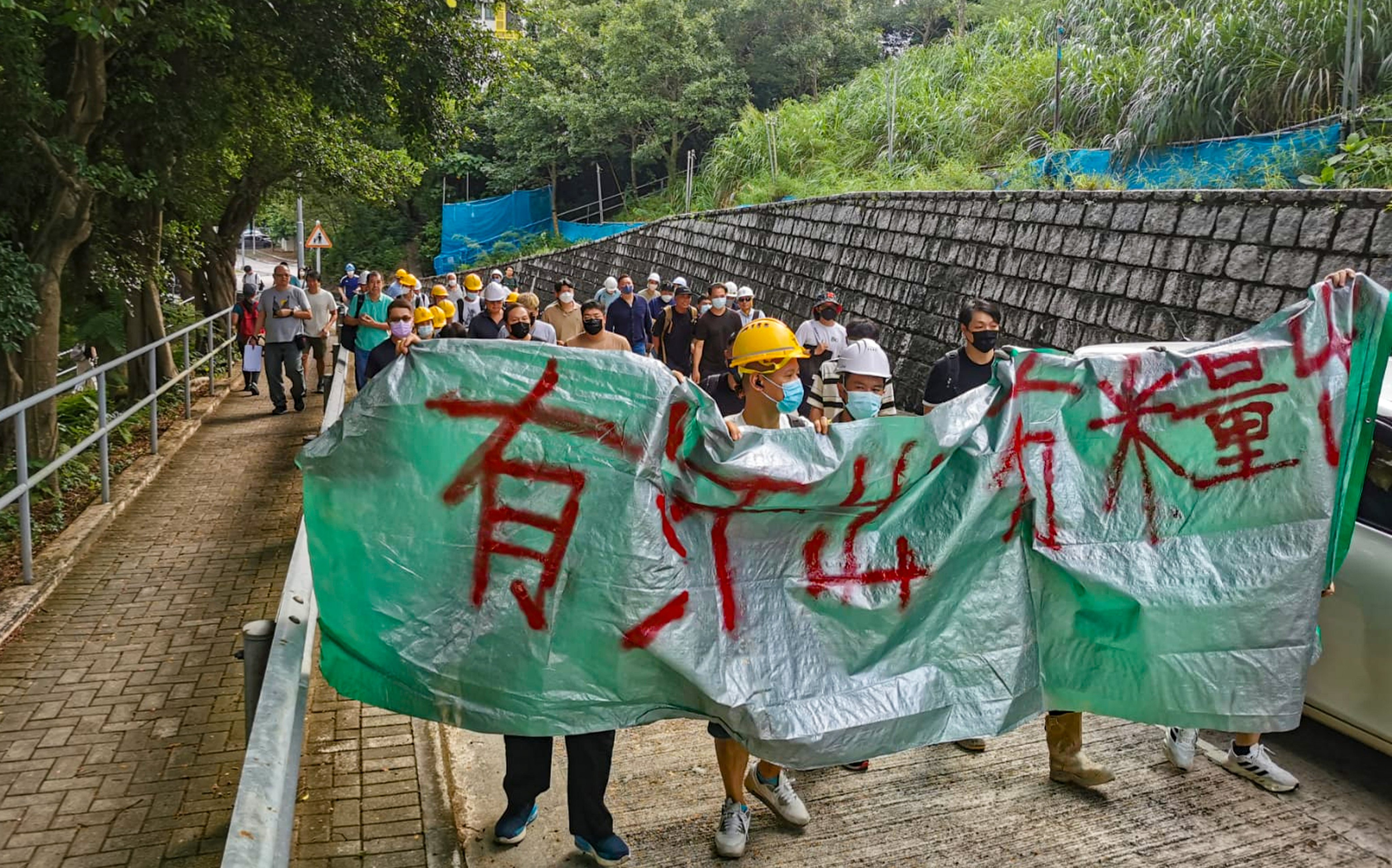 About 30 workers staged a protest at the site of the Hong Kong University of Science and Technology project, displaying a banner that read: “unpaid toil and sweat”. Photo: HKCIEGU