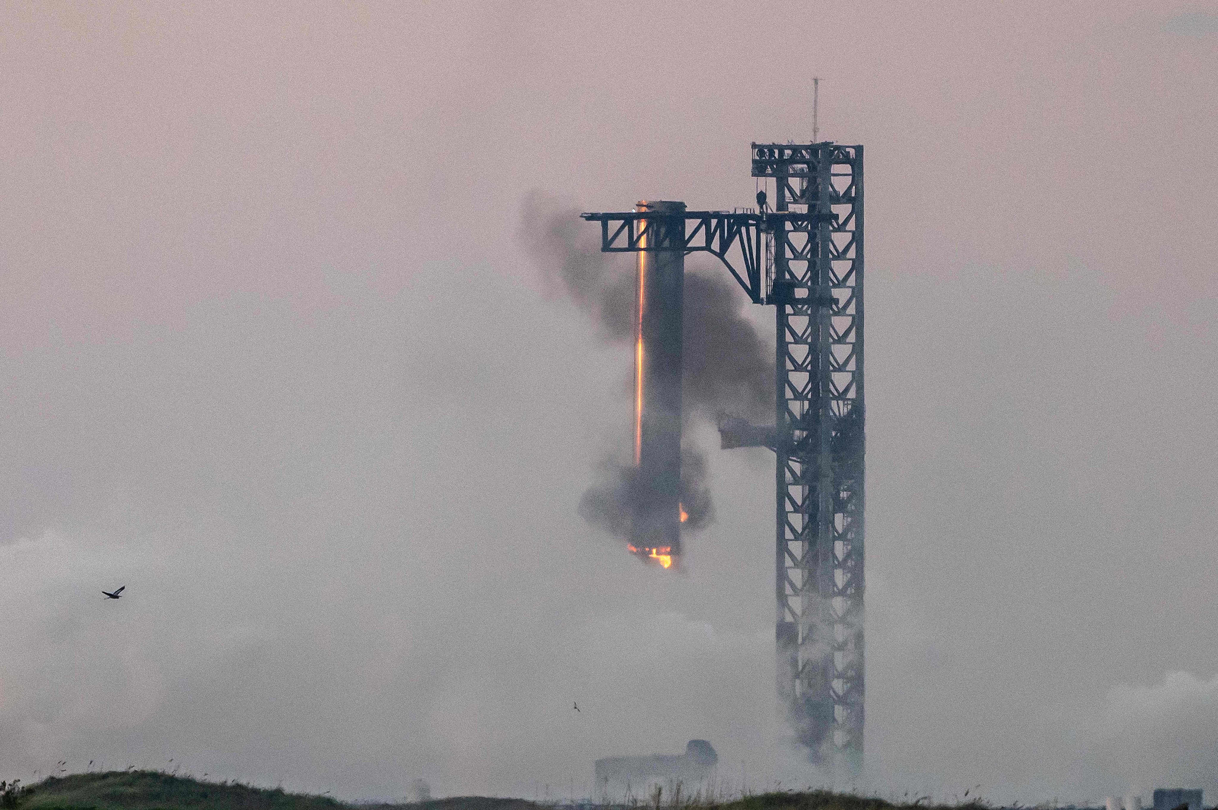 Starship’s Super Heavy Booster being grappled at the launch pad. Photo: AFP