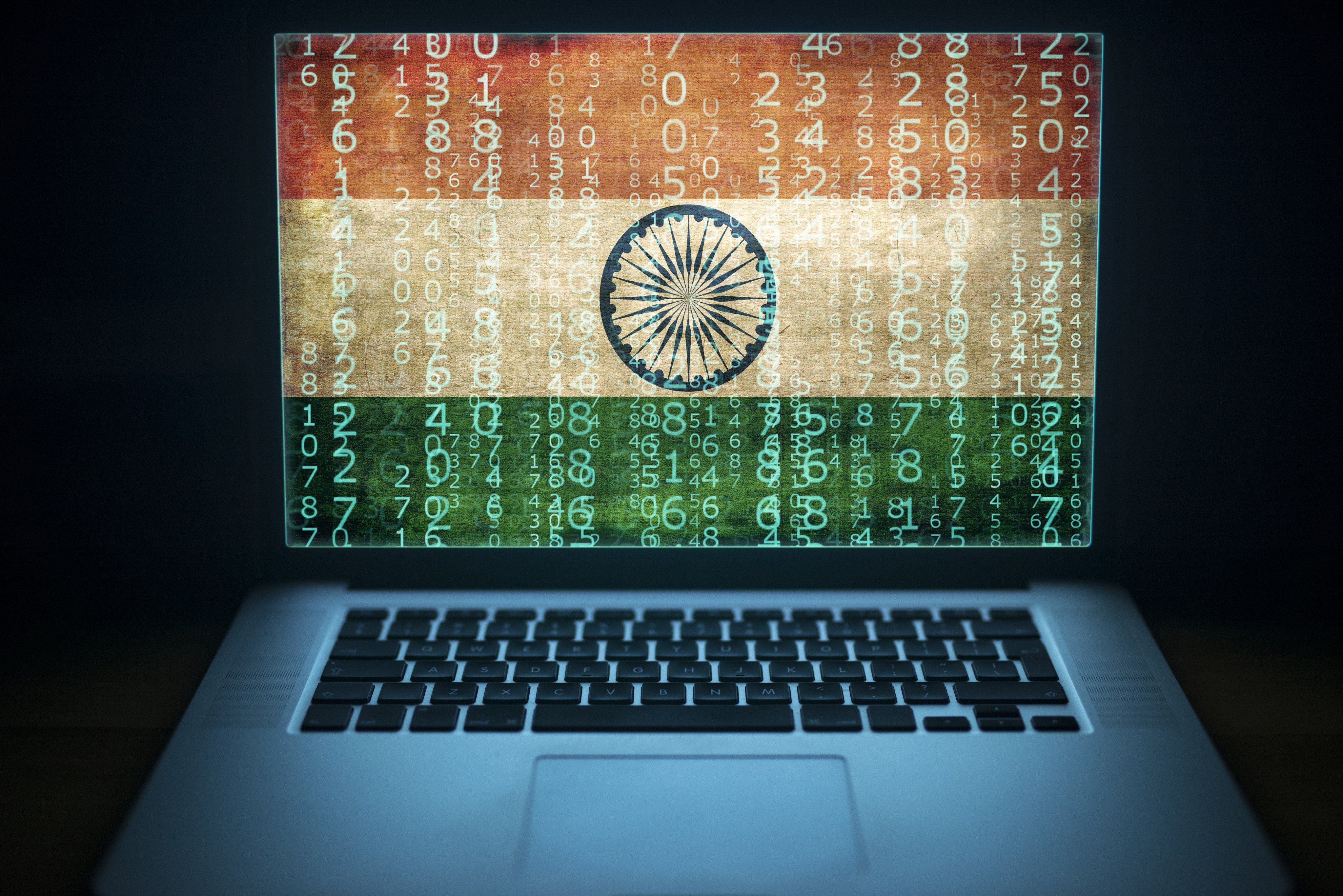 A laptop with binary computer code and an India flag on the screen. Photo: Shutterstock
