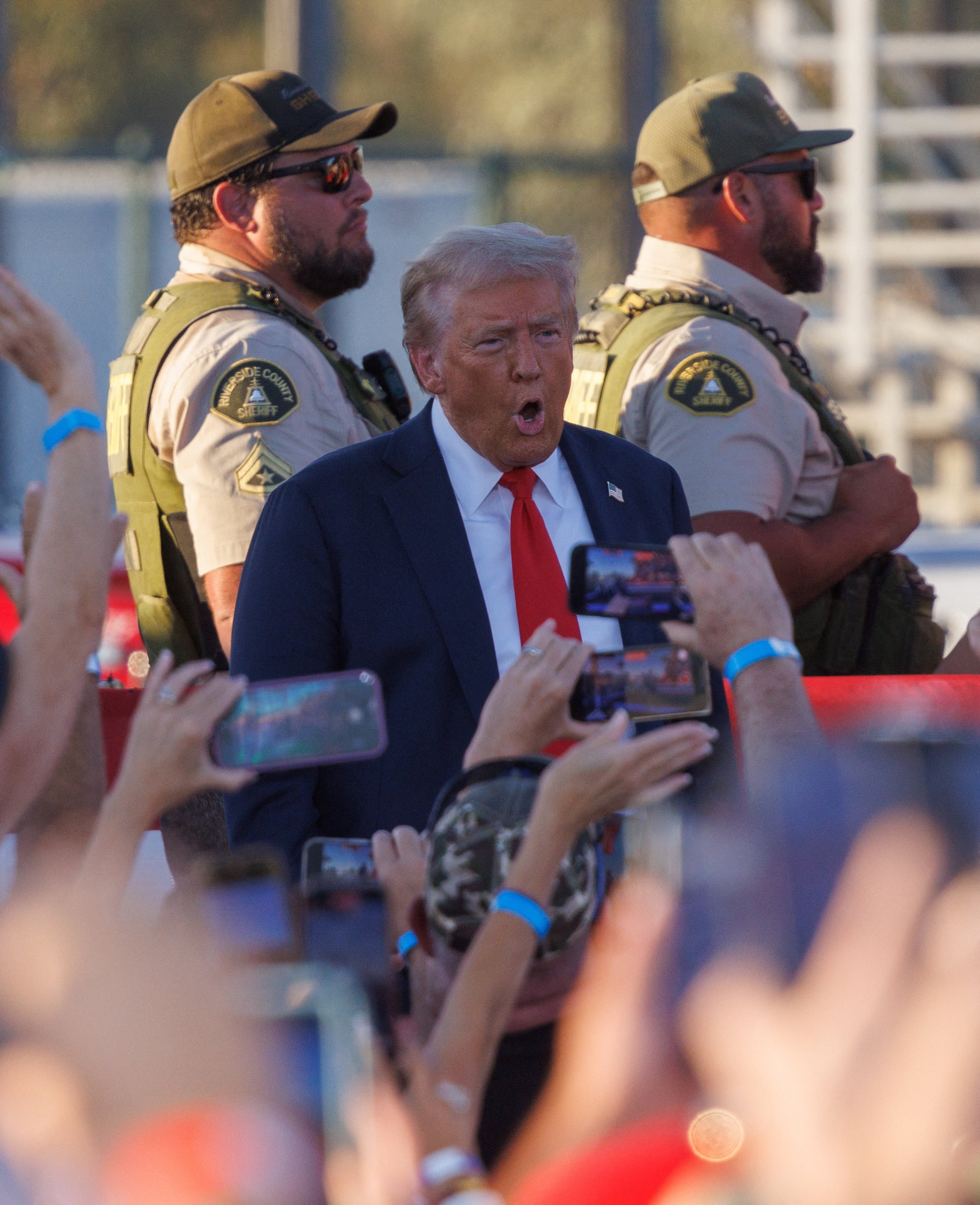 Riverside Country Sheriffs stand guard as Donald Trump arrives at his rally in Coachella, California, on Saturday. Photo: Reuters