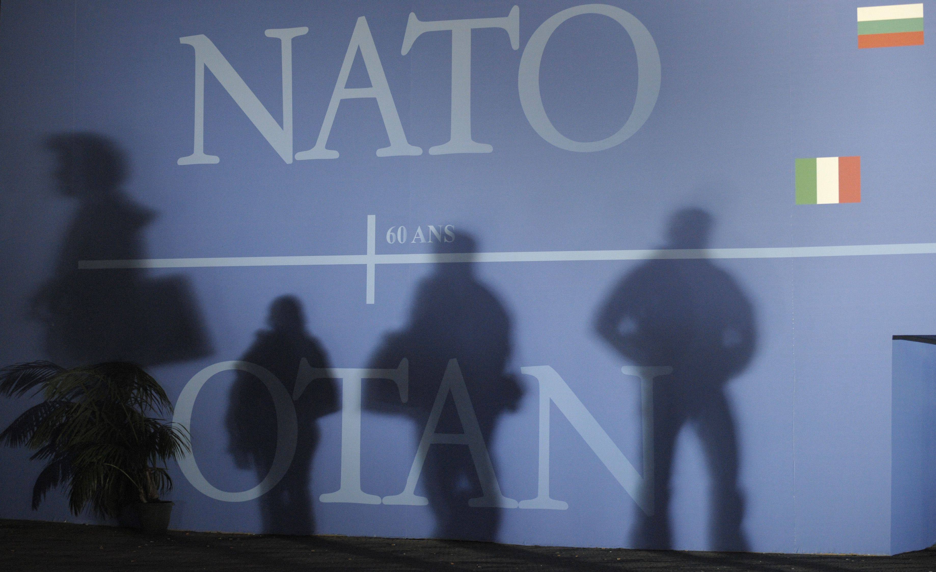 Nato summit attendees’ shadows cast on a wall decorated with the Nato logo and flags. Photo: AFP