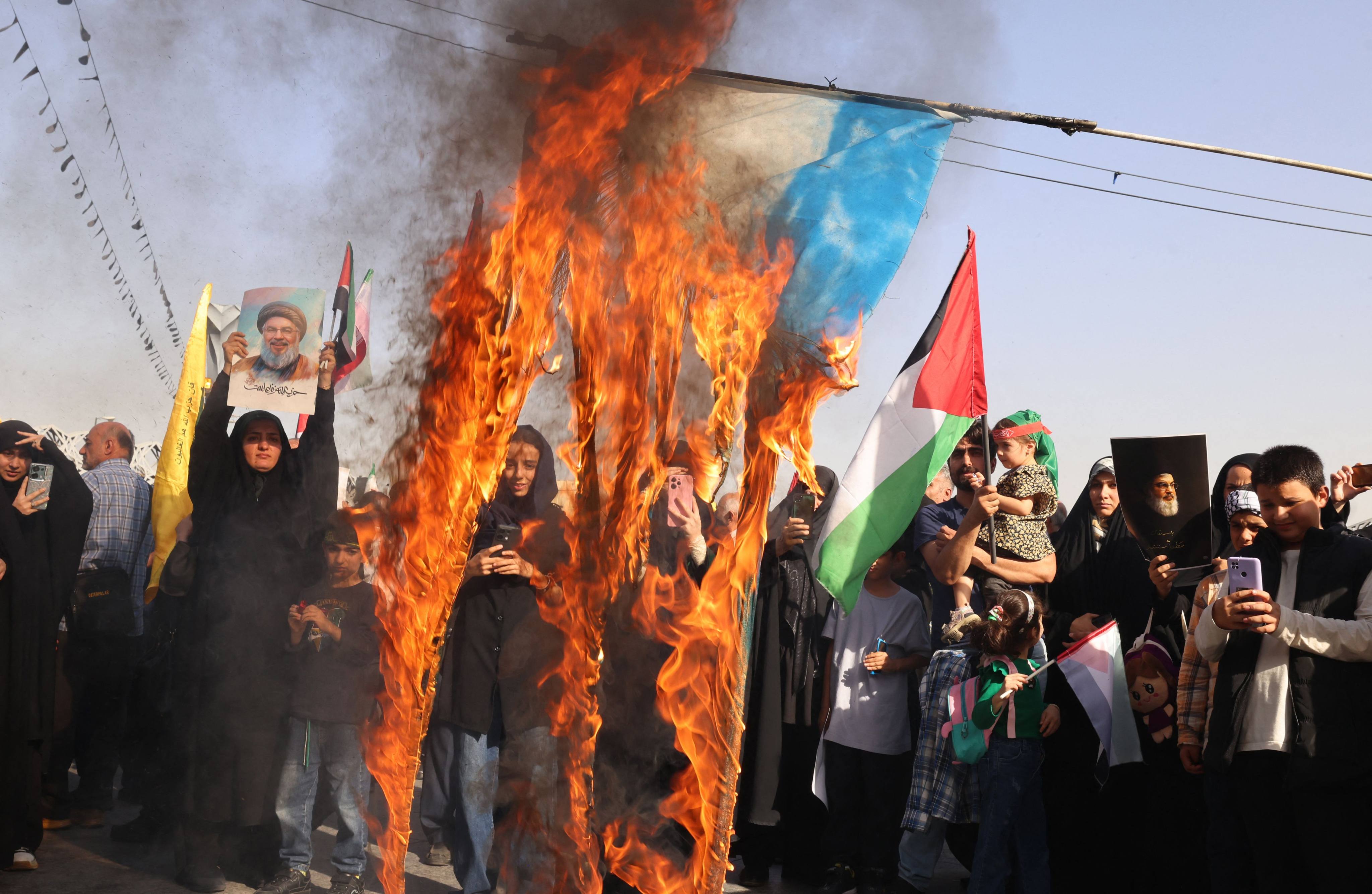 Iranians burn an Israeli flag during a rally in Tehran on October 2, 2024, a day after Iran fired a barrage of missiles at Israel. Photo: AFP