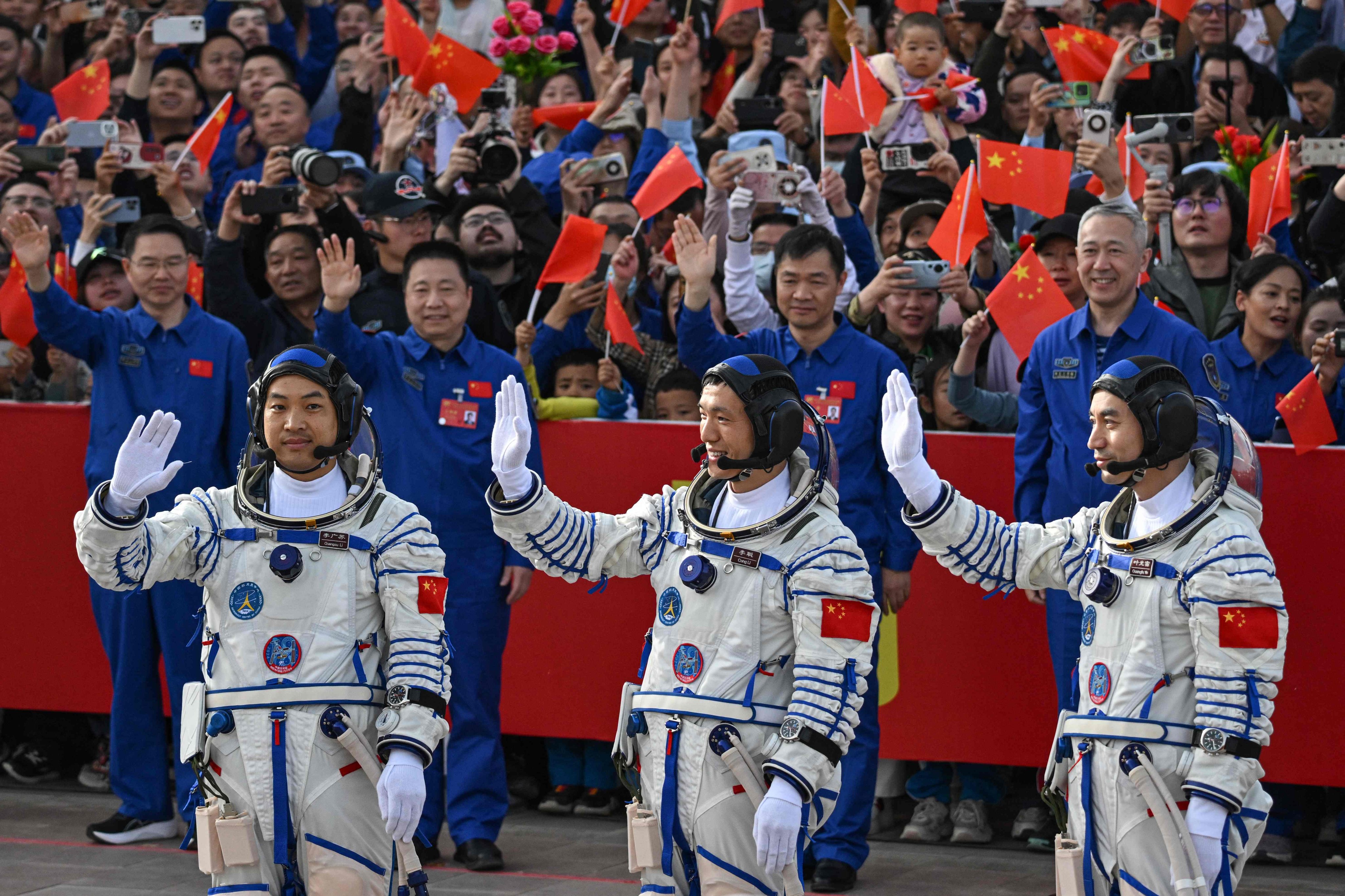 Chinese astronauts (from left) Li Guangsu, Li Cong and Ye Guangfu wave before their journey to the Tiangong space station aboard the Shenzhou-18 in April. Photo: AFP