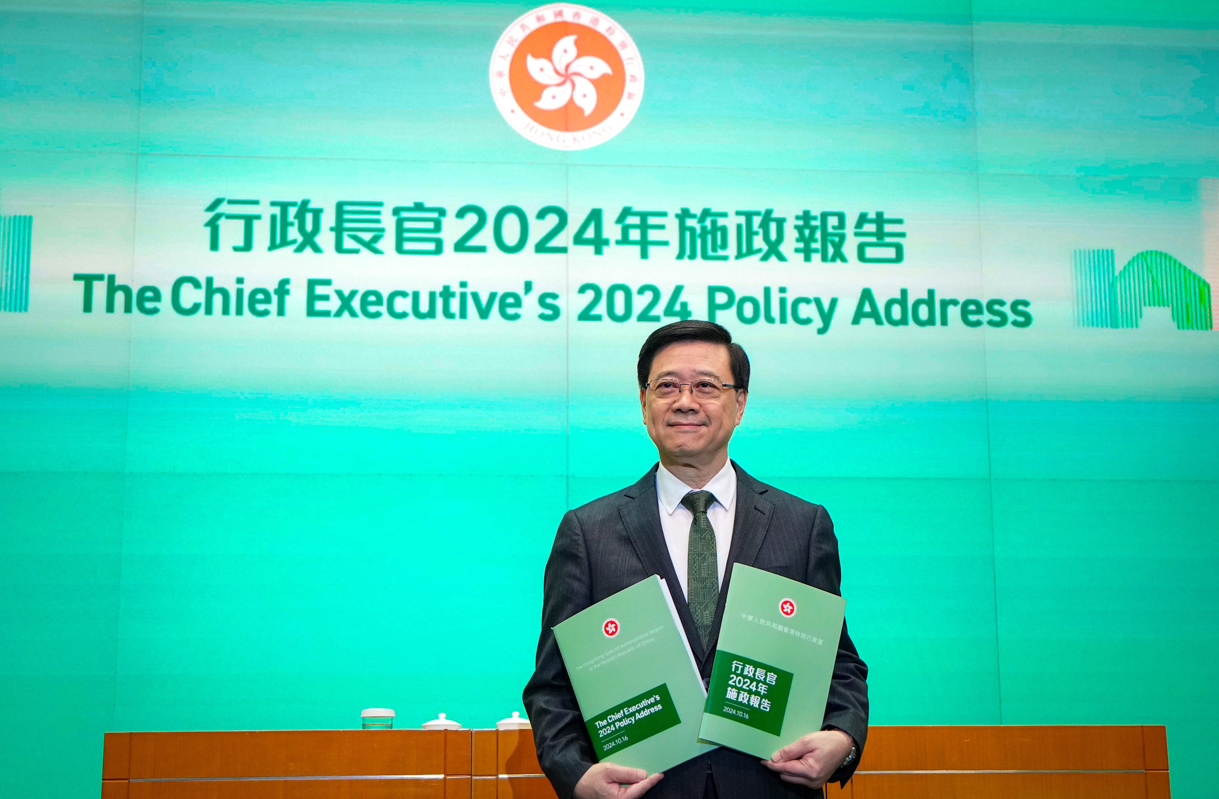 John Lee poses with copies of his latest policy blueprint. Photo: Eugene Lee