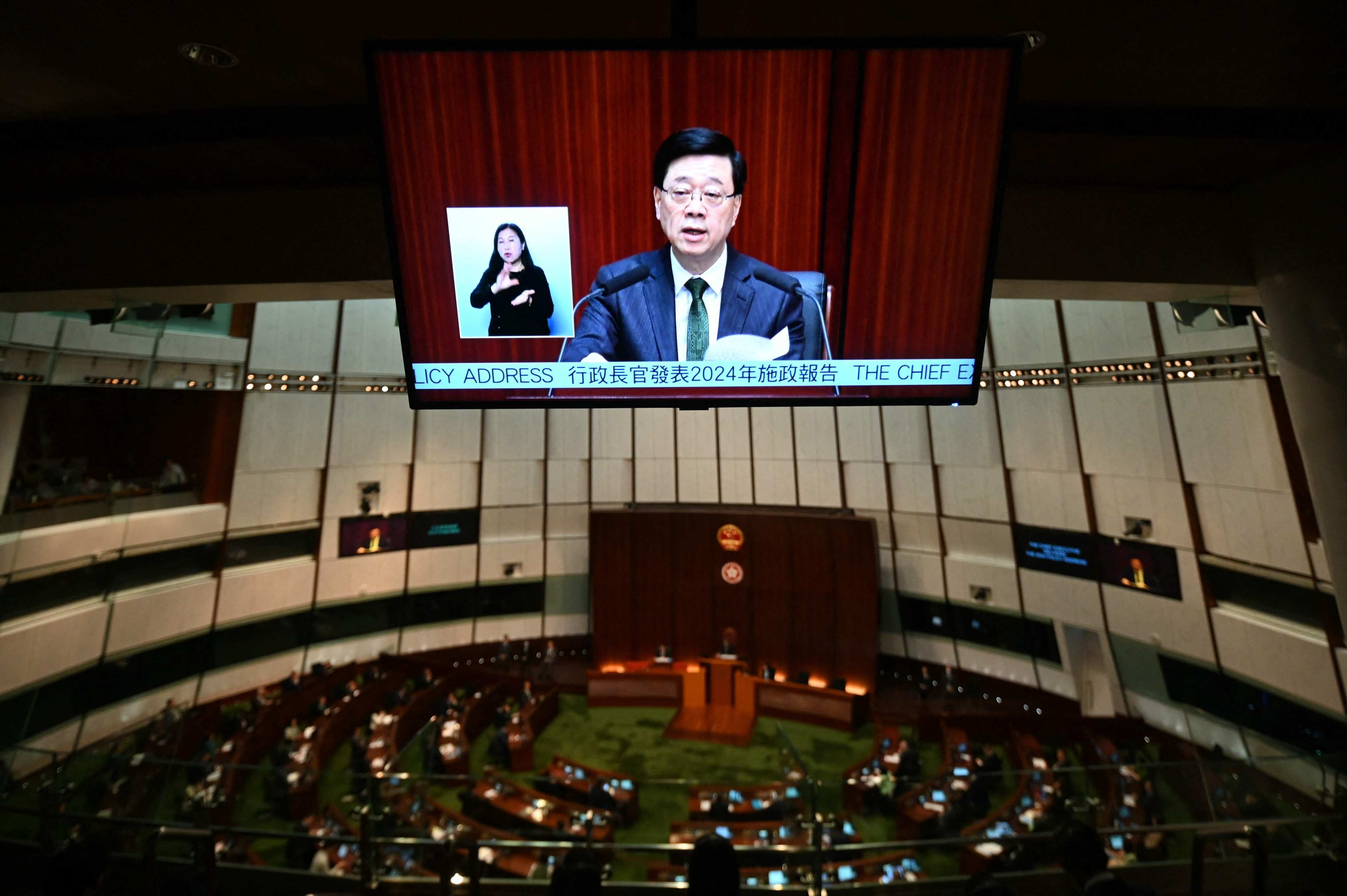 A television screen shows Hong Kong Chief Executive John Lee delivering his annual policy address in the Legislative Council chamber in Hong Kong on Wednesday. Photo: AFP