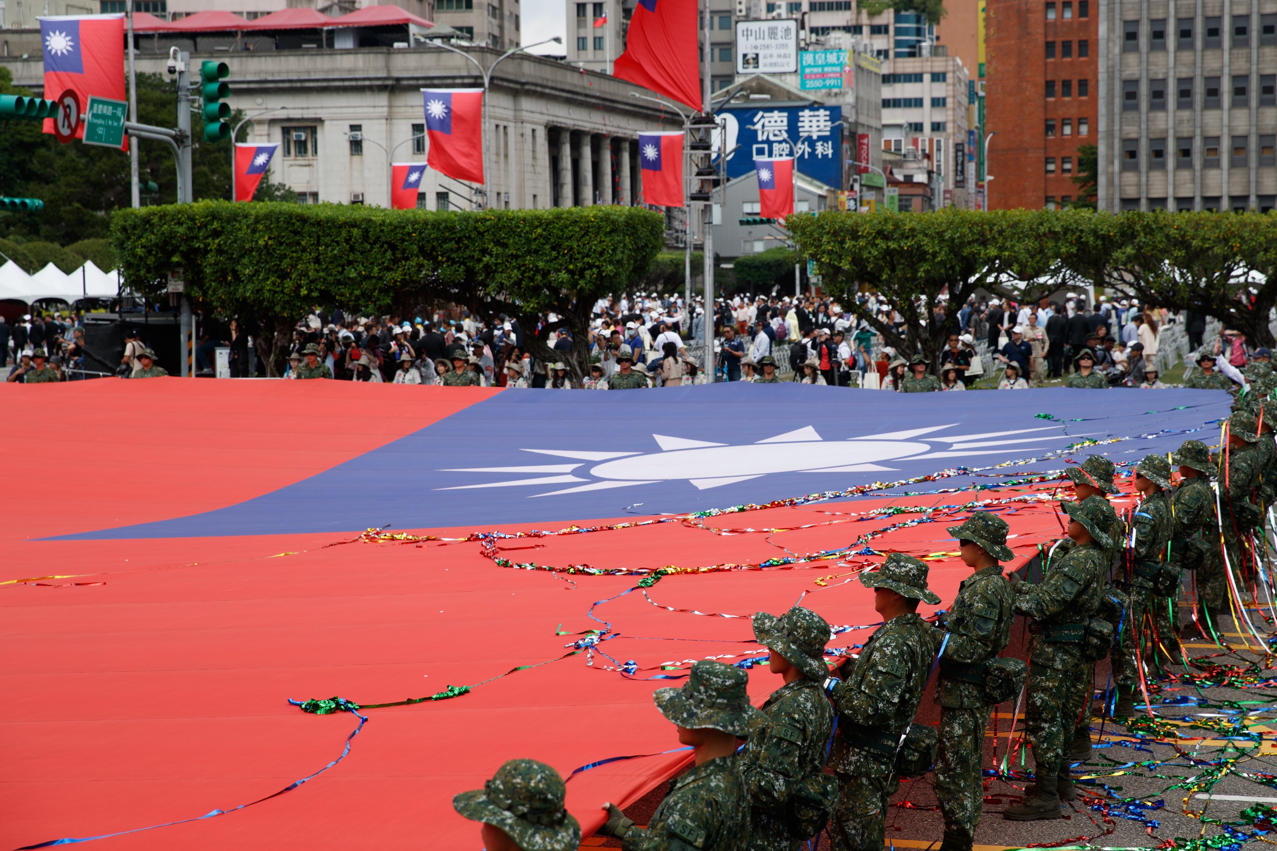 Taiwanese soldiers display the self-governed island’s national flag during Taiwan’s National Day celebration in Taipei on Thursday. Photo: EPA-EFE