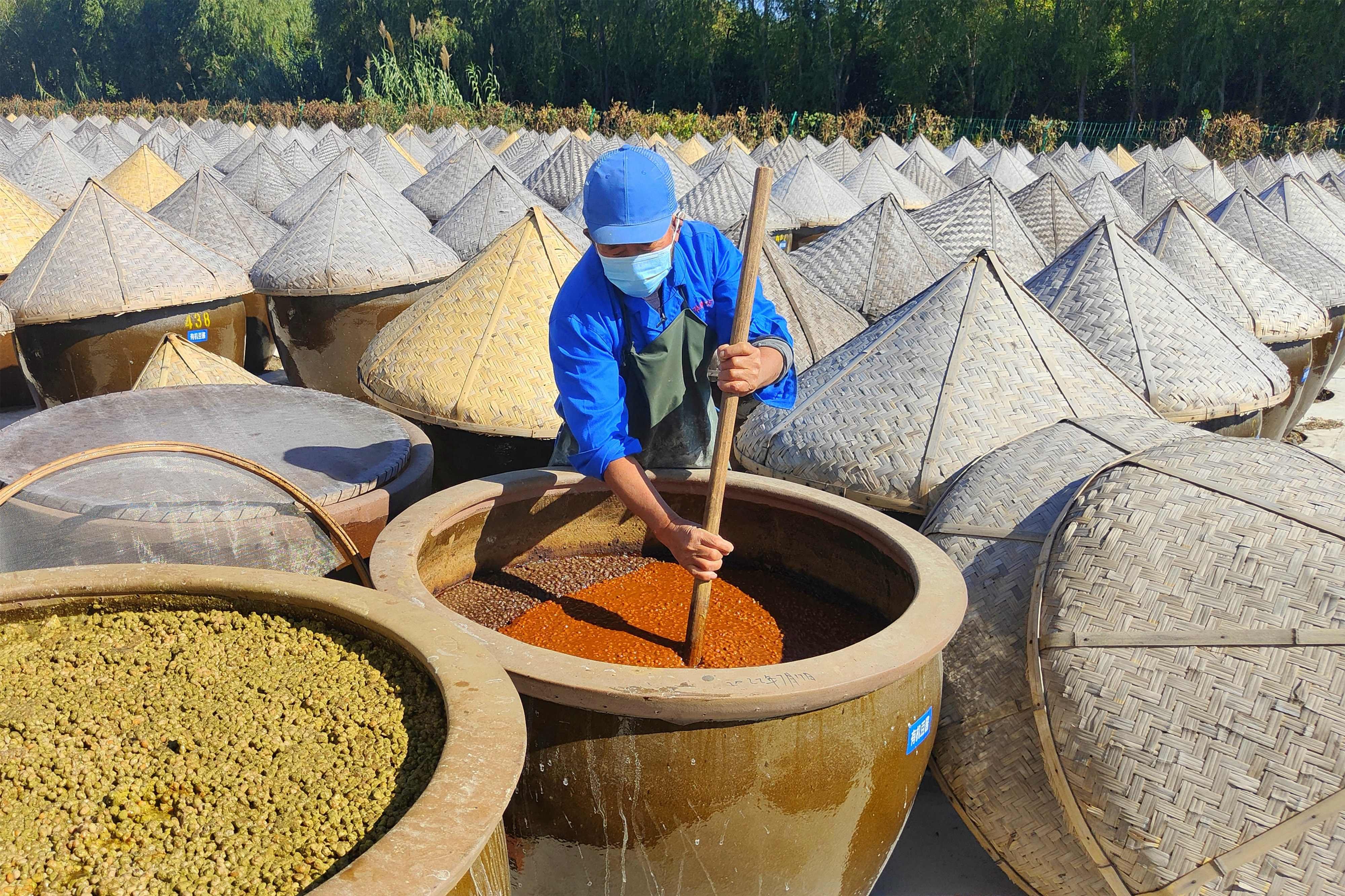 This photo taken on October 19, 2022 shows a worker producing soy sauce in Rugao in China’s eastern Jiangsu province. Photo: AFP