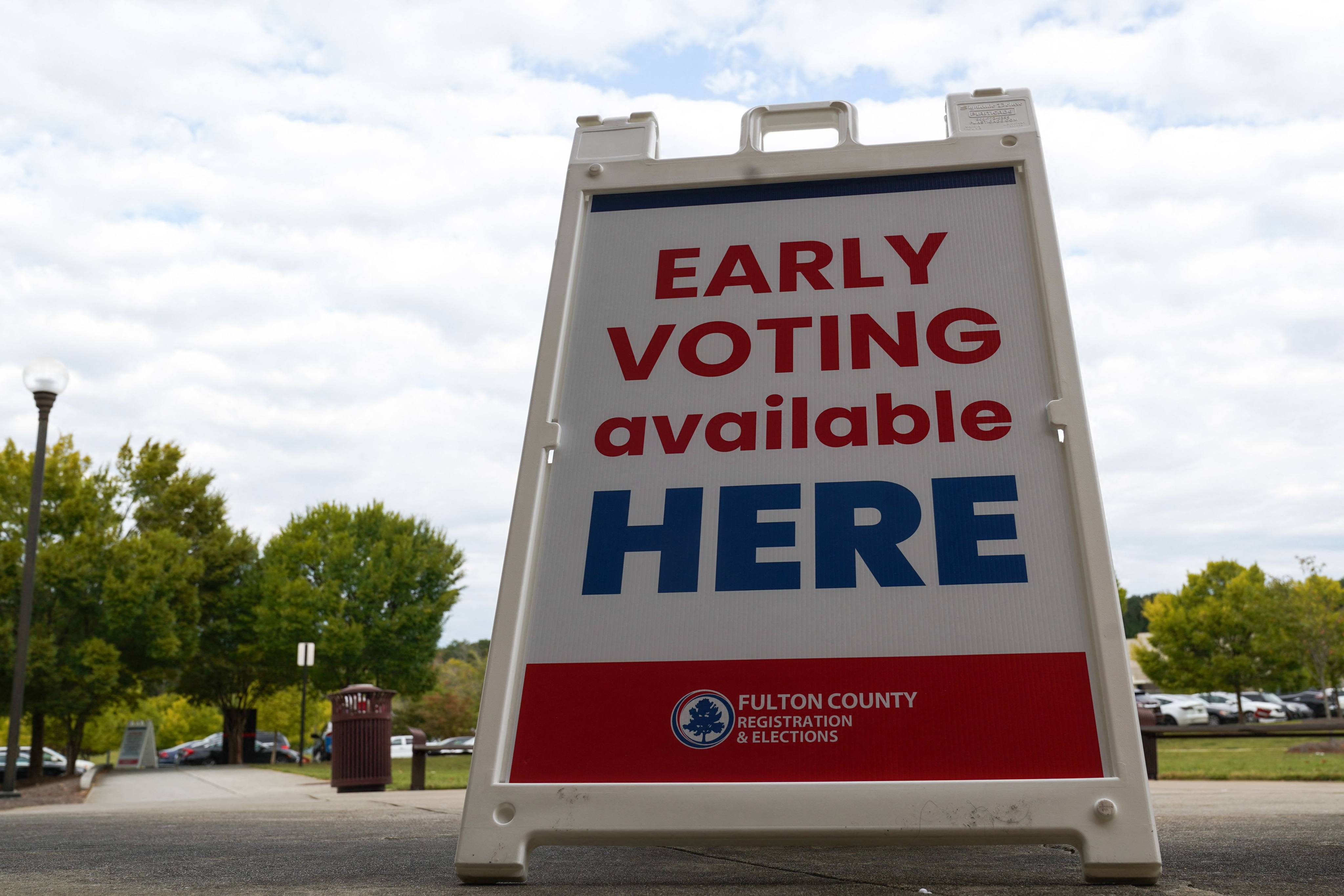 Signs direct voters to cast their ballots on the first day of early voting in Atlanta, Georgia, on Tuesday. Photo: AFP