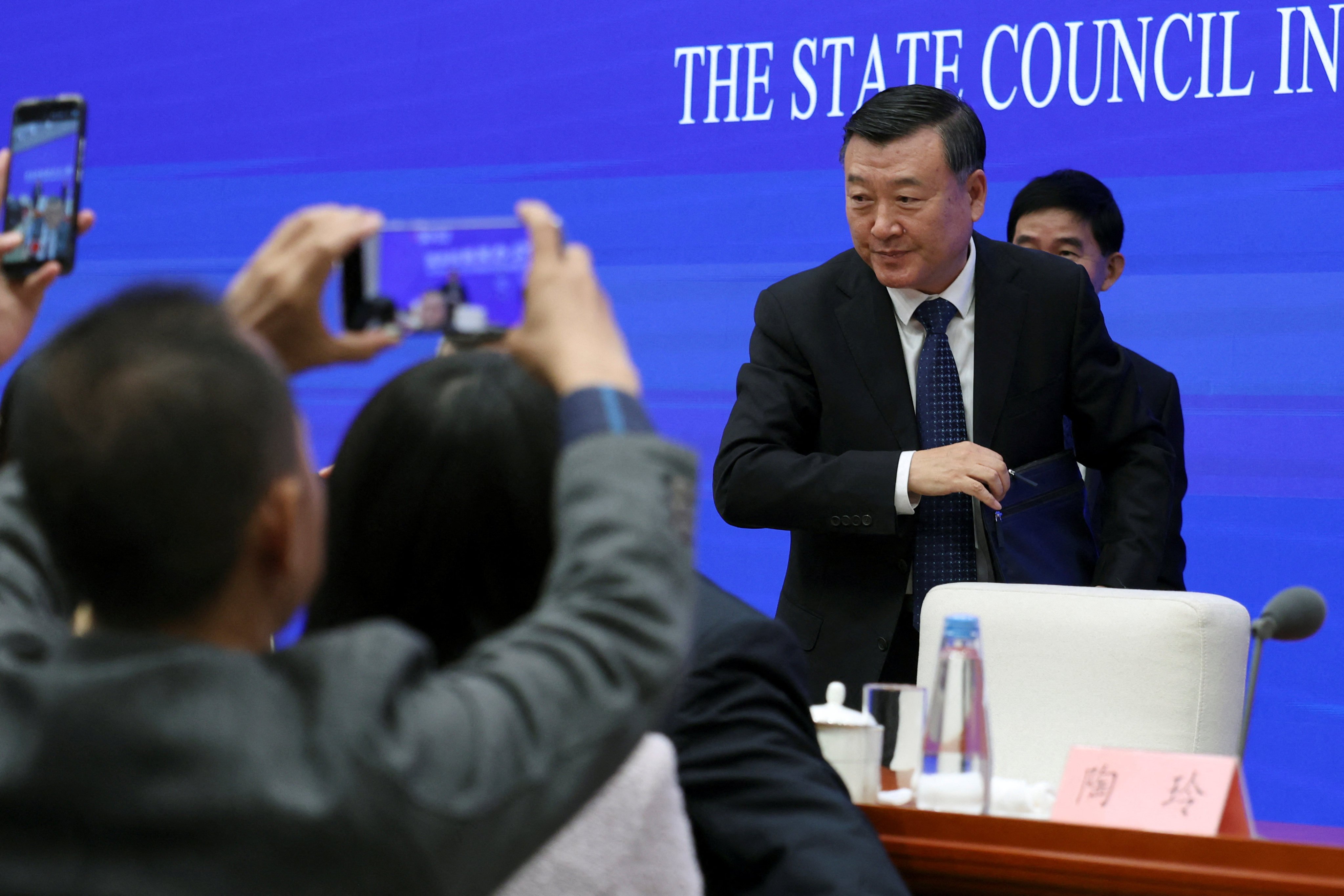 Chinese Housing and Urban-Rural Development Minister Ni Hong leaves at the end of a press conference on the property sector in Beijing. Photo: Reuters