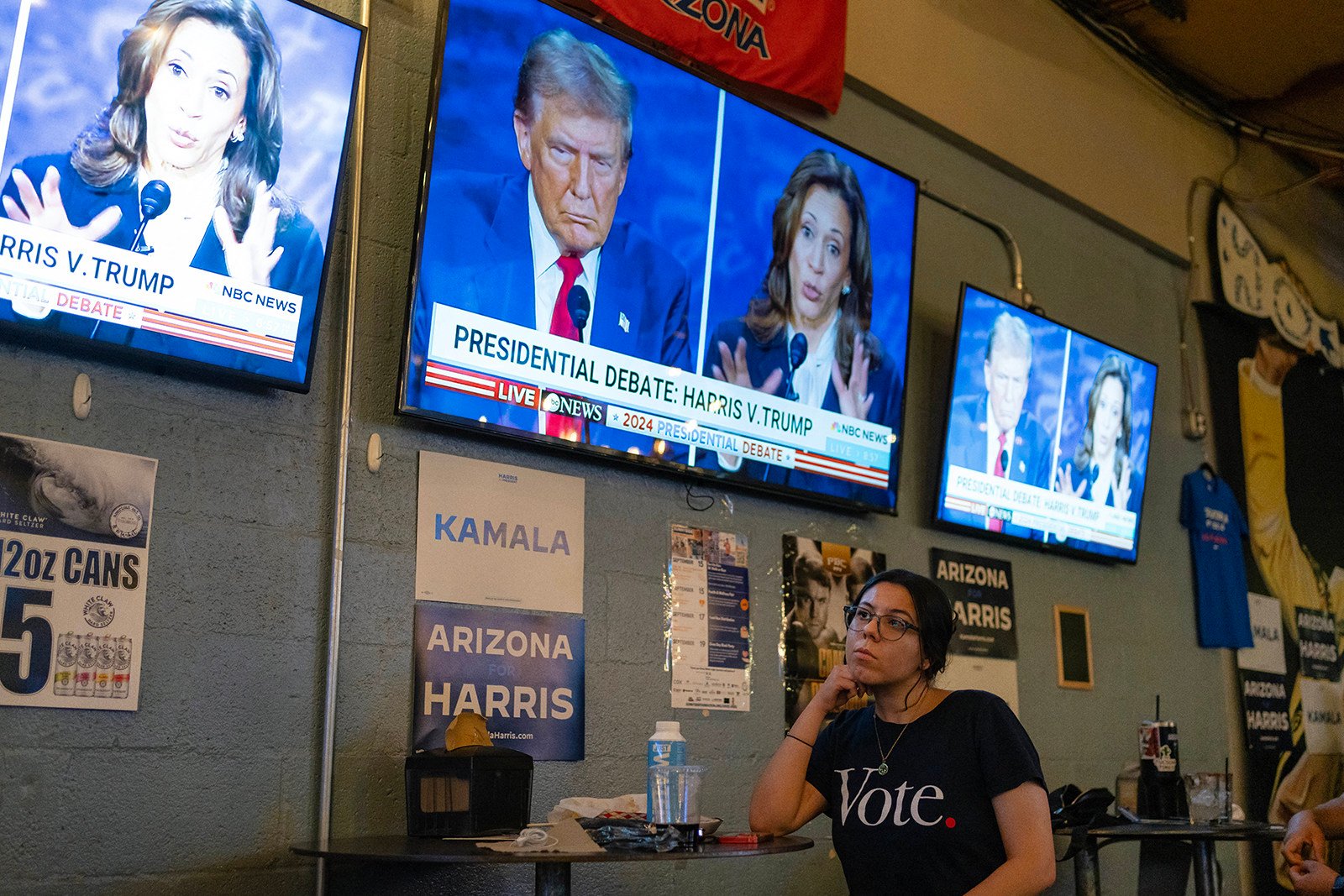 A woman watches the US presidential debate between US Vice-President Kamala Harris and former US president Donald Trump at an American Eat Company food court in Tucson, Arizona, on September 10. Photo: AFP