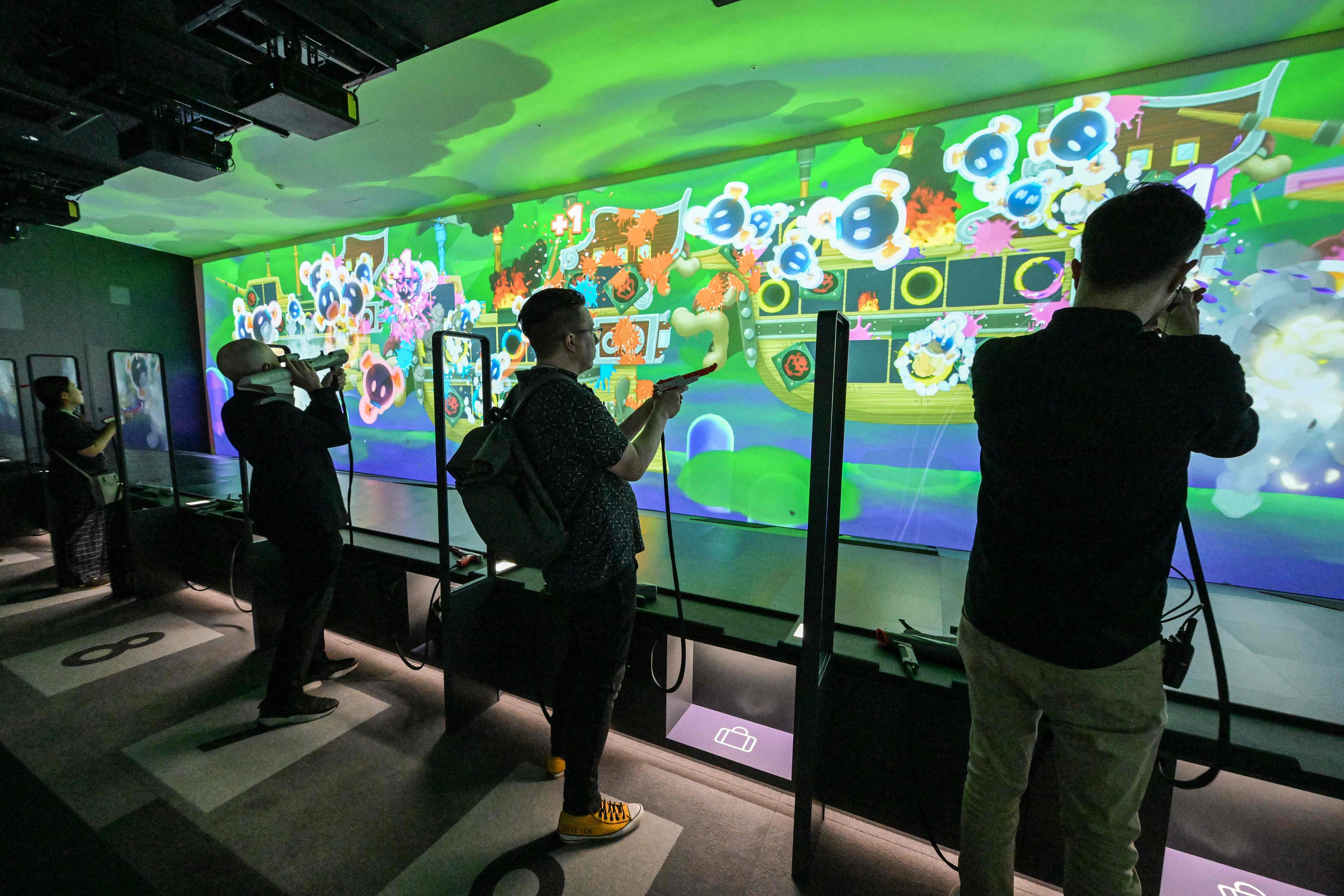 Visitors play a shooting game at the new Nintendo Museum. Photo: AFP