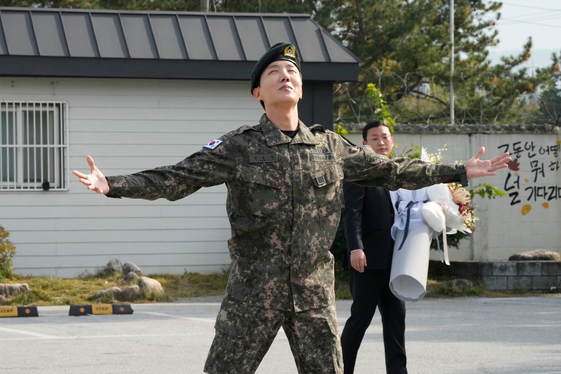 J-Hope reacts after being discharged from a mandatory military service outside of an army base in Wonju. Photo: AP