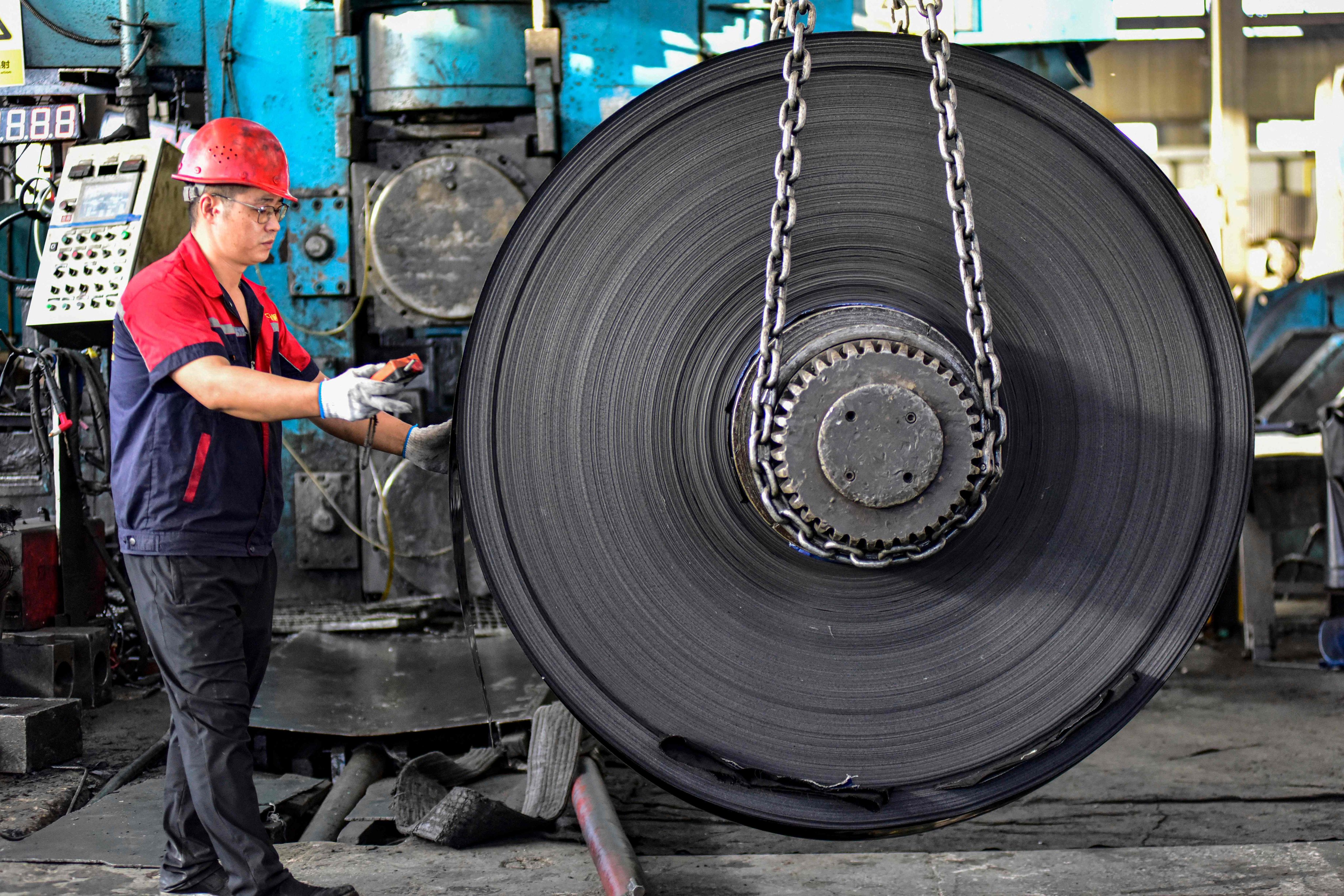 An employee works at a factory that makes stainless steel products in Qingzhou, Shandong province, on October 13. Photo: AFP