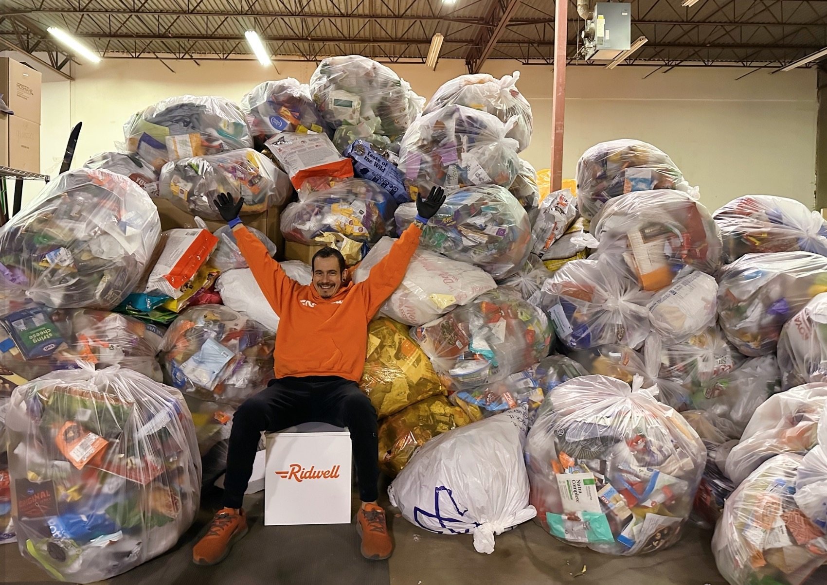 A Ridwell staff member poses with bags of items destined to be recycled. The company gathers hard-to-recycle items for a fee, picking up where city recyclers leave off. Photo: Facebook/Ridwell