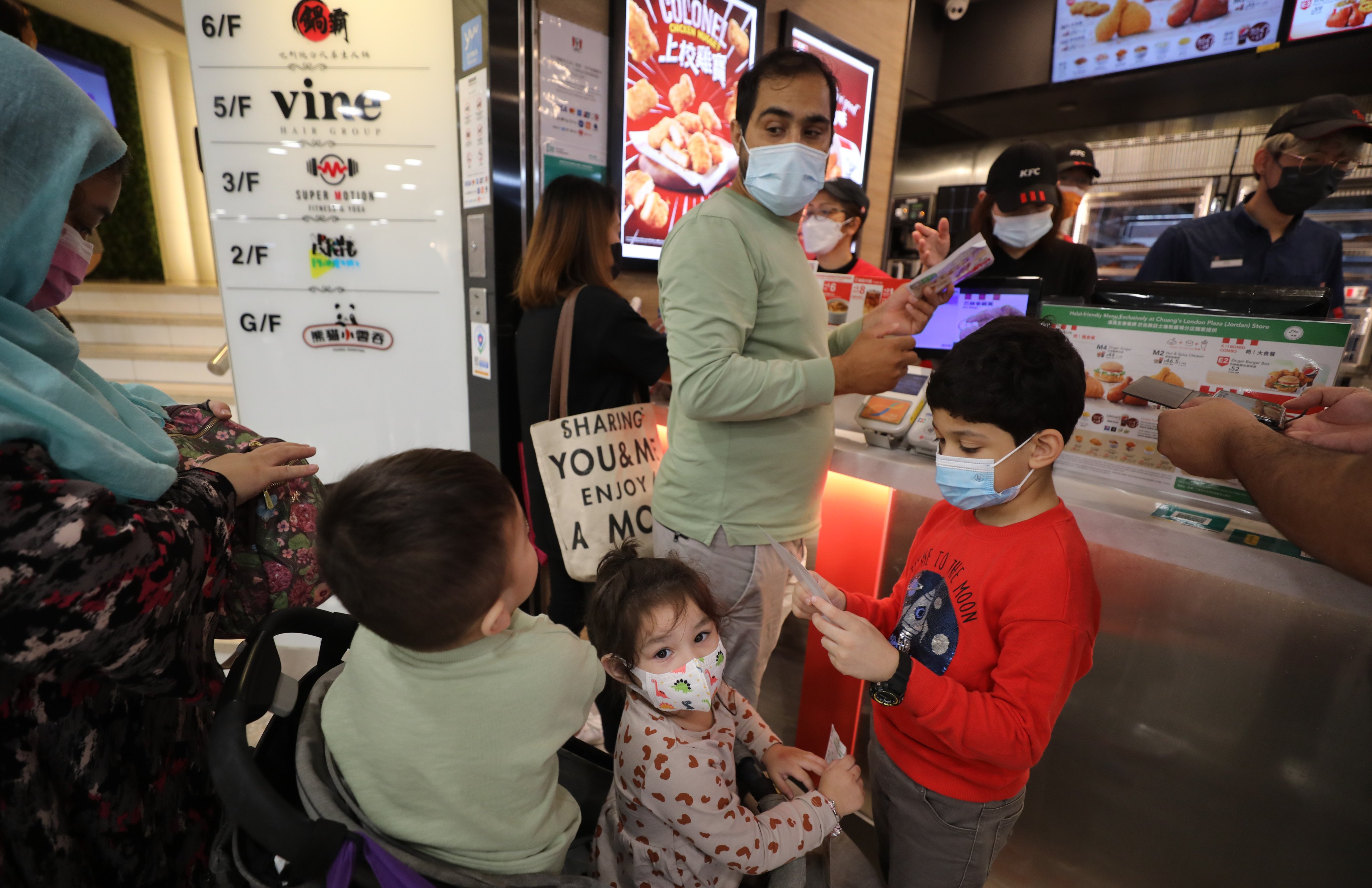 A Muslim family  buys a meal at a halal-certified KFC store, on November 4, 2022, in Hong Kong. Photo: Xiaomei Chen