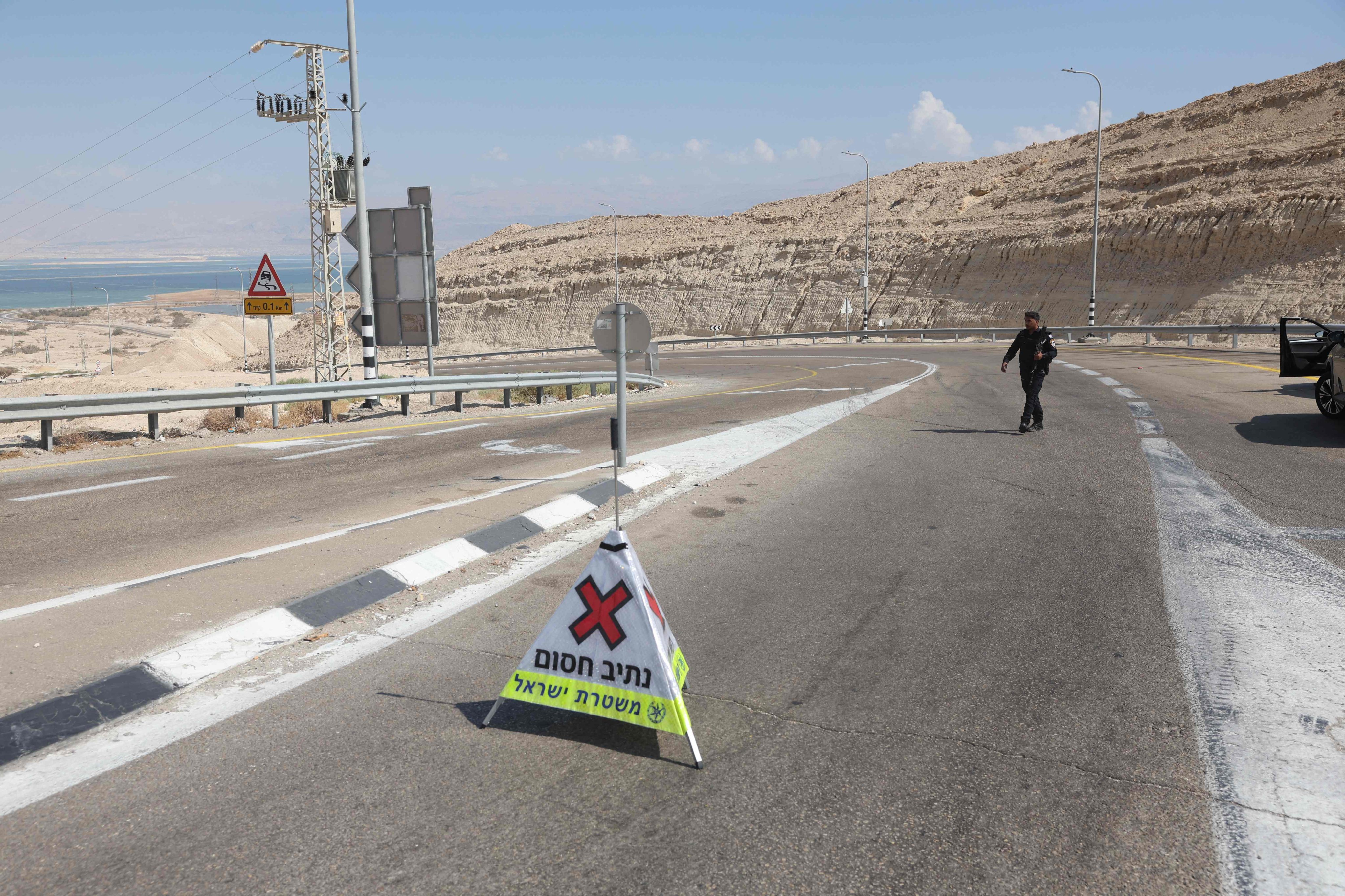 Israel police block the road at the entrance of the southern Israeli city of Arad, north of the Negev desert, after the army said two attackers entered Israeli territory from Jordan at the southern tip of the Dead Sea  and opened fire at Israeli troops before being “neutralised”. Photo: AFP