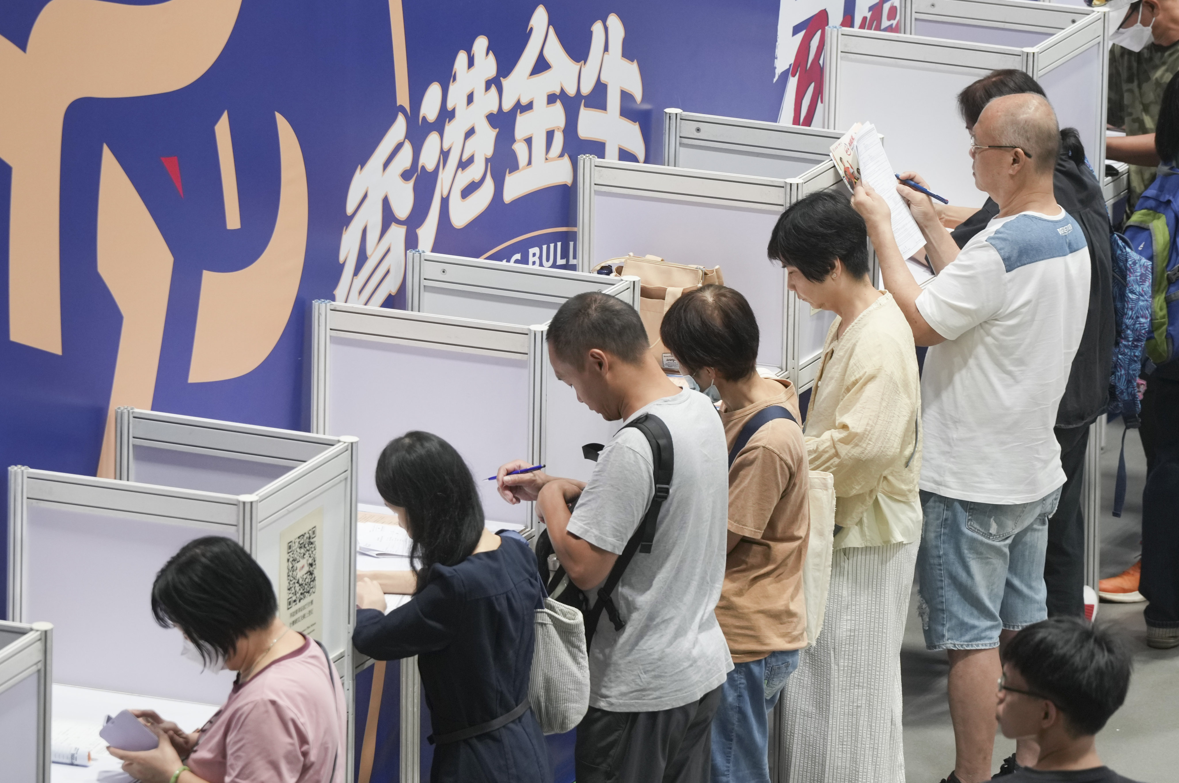 Job seekers looks for work opportunities  at an employment  fair in Wan Chai. Photo: May Tse