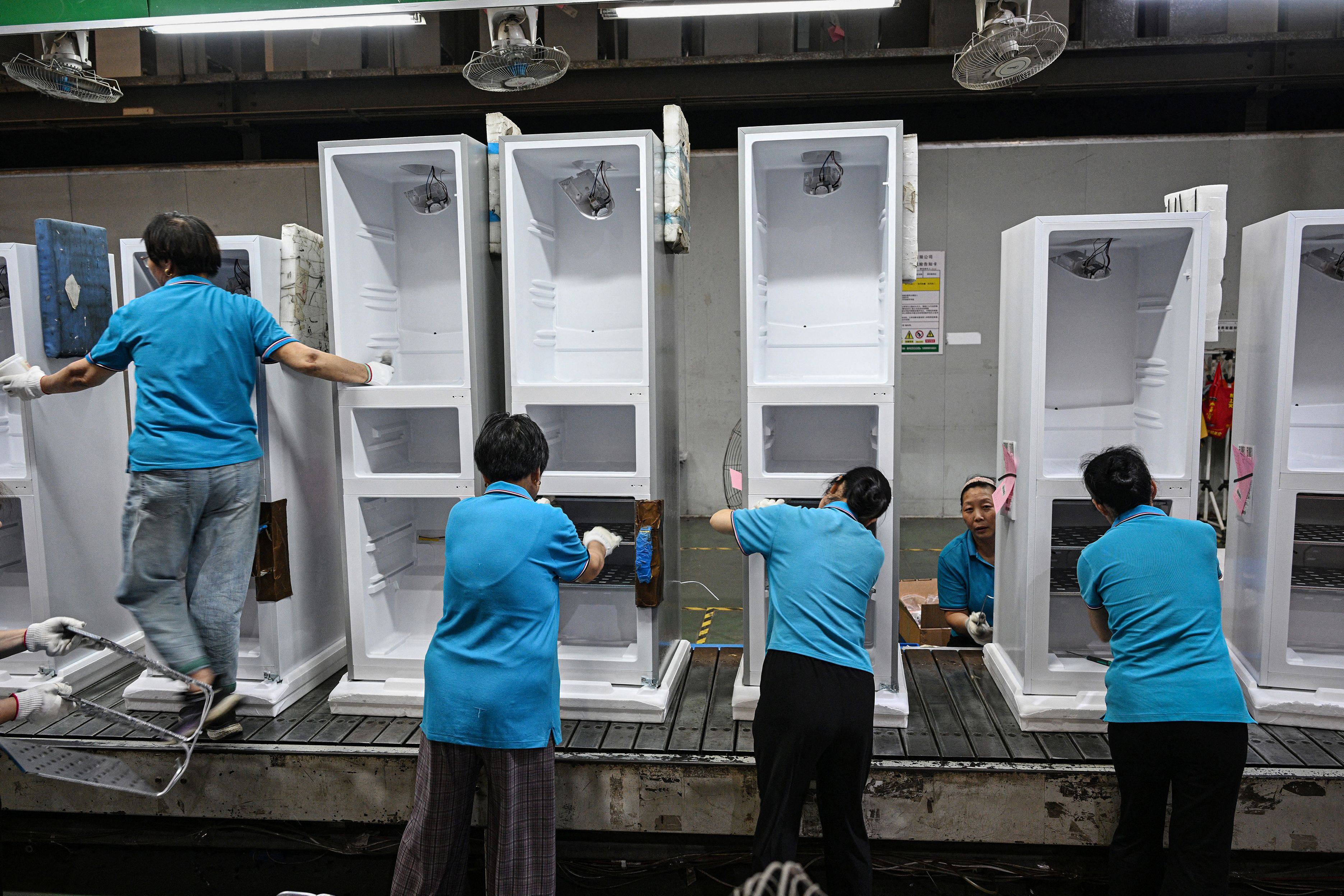 Employees work on a refrigerator assembly line in China’s Jiangsu province. Sales of household appliances across the country grew by double digits last month. Photo: AFP